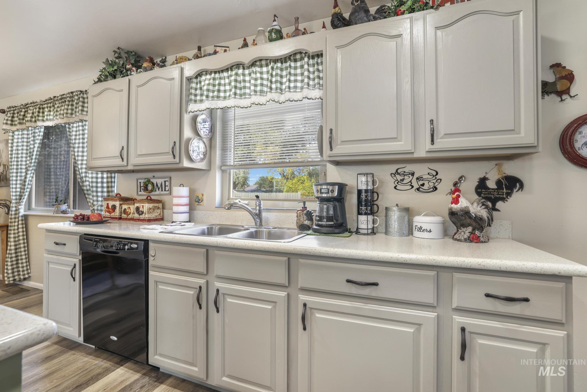 Kitchen with light countertops, dishwasher, and light wood-type flooring