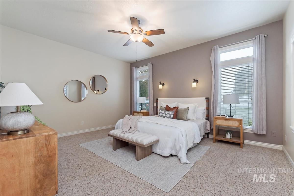 Bedroom featuring multiple windows and ceiling fan