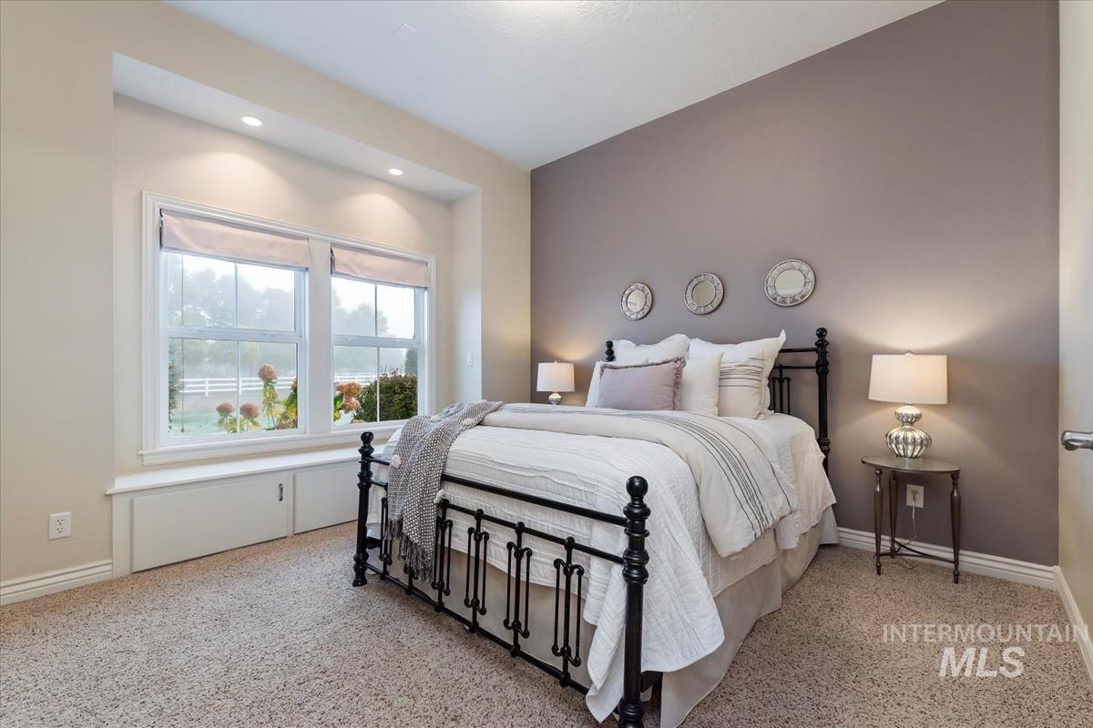 Bedroom with light carpet and recessed lighting