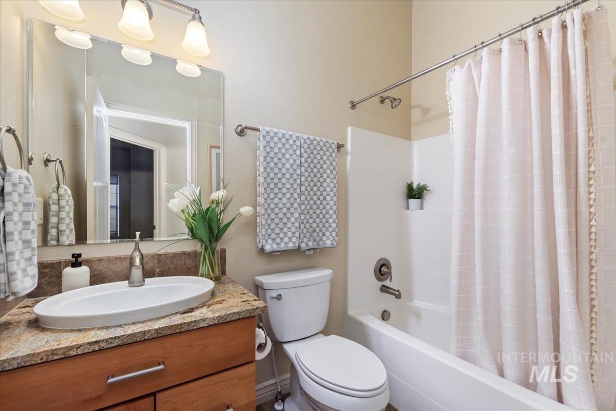 Bathroom featuring shower / tub combo and vanity