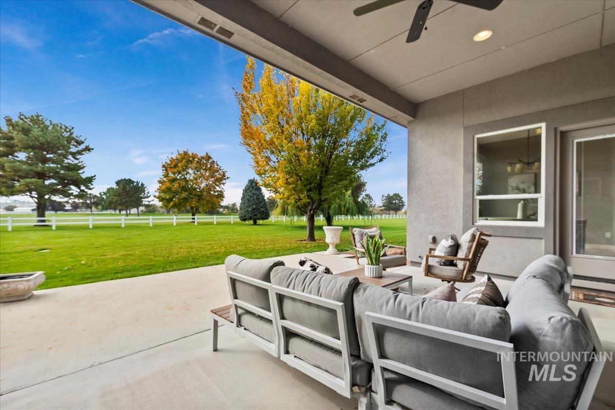 View of patio with an outdoor living space, ceiling fan, and a baseboard heating unit