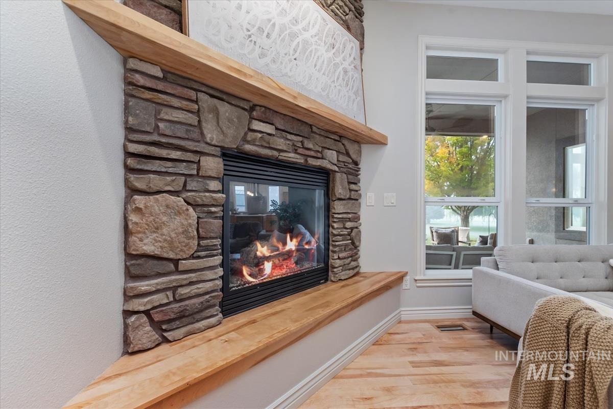 Detailed view of wood finished floors and a fireplace