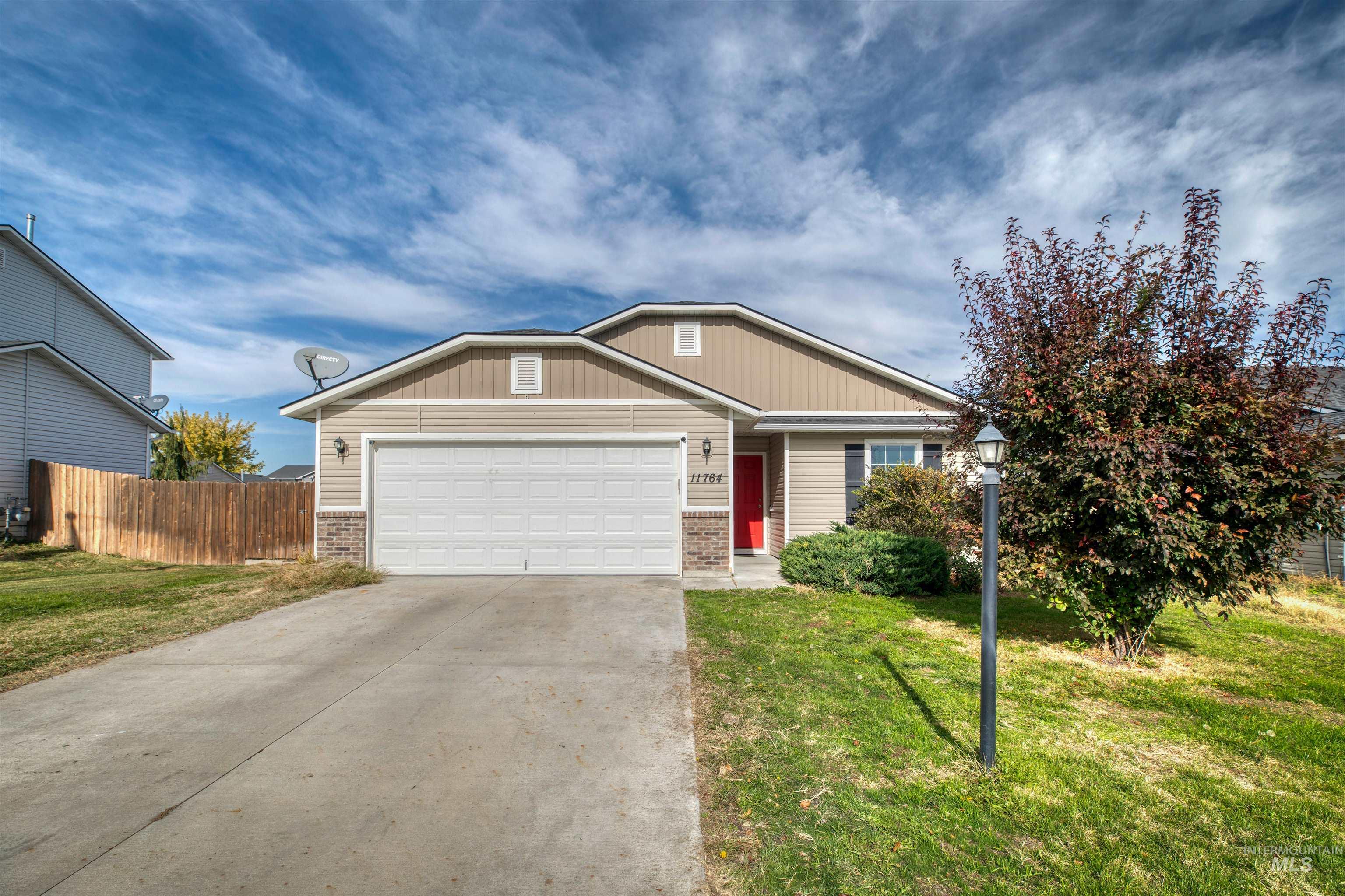View of front of house with brick siding, a garage, and concrete driveway