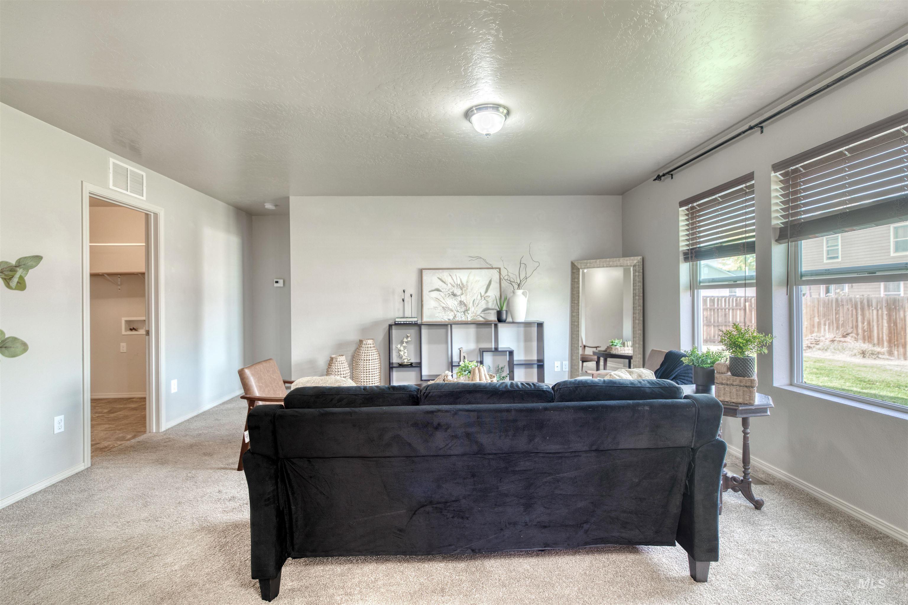 Living room with carpet flooring and a textured ceiling