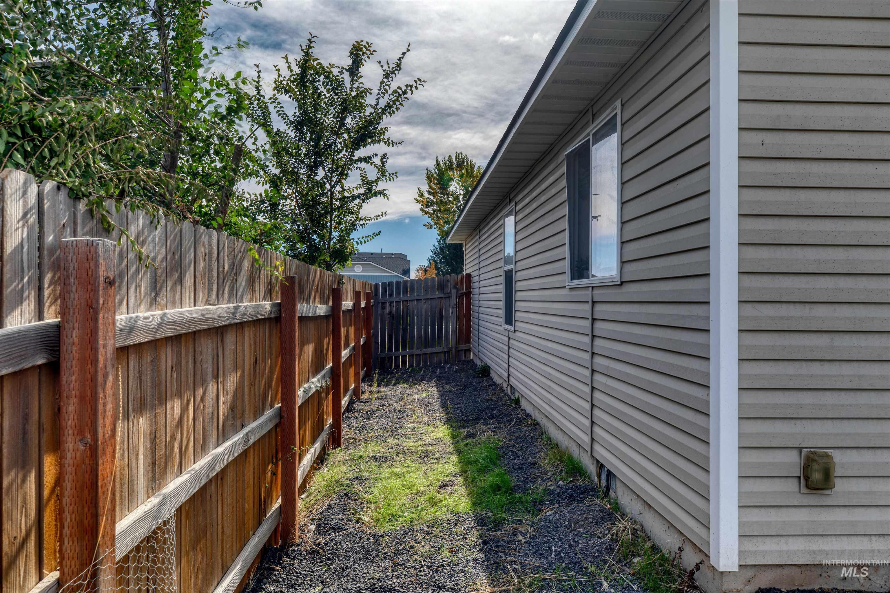 View of side of home featuring a fenced backyard