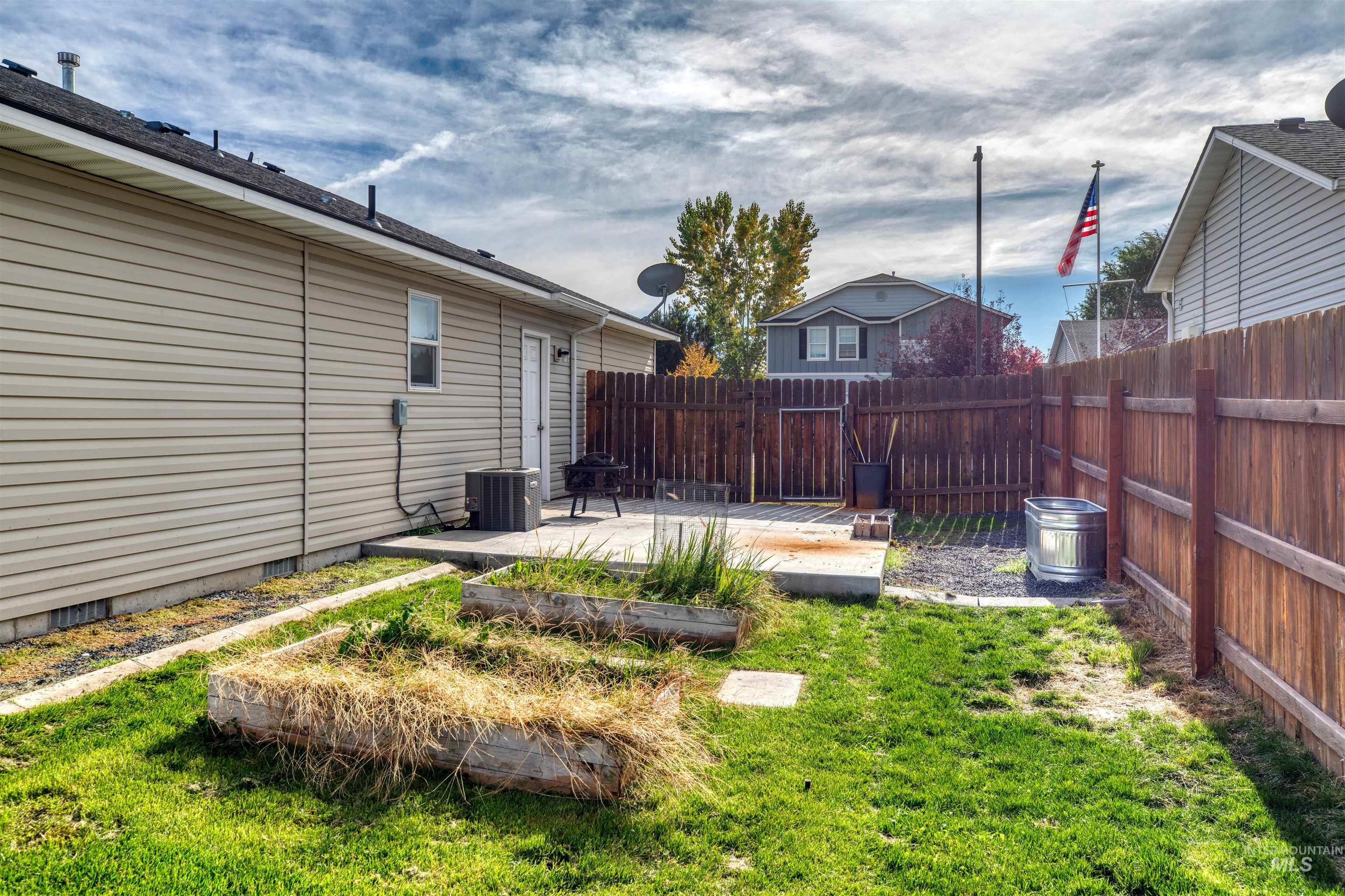 Fenced backyard with a patio