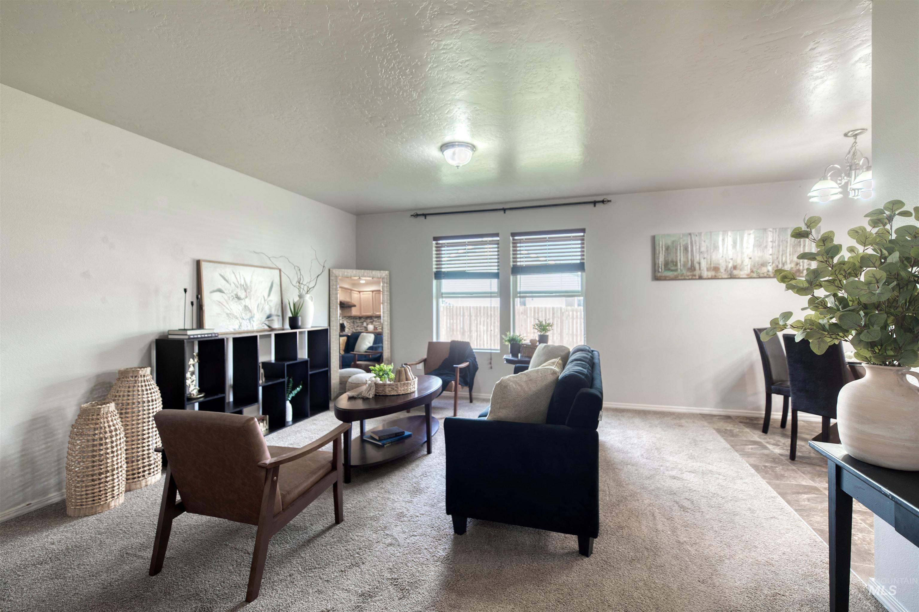 Living area featuring carpet floors and a textured ceiling