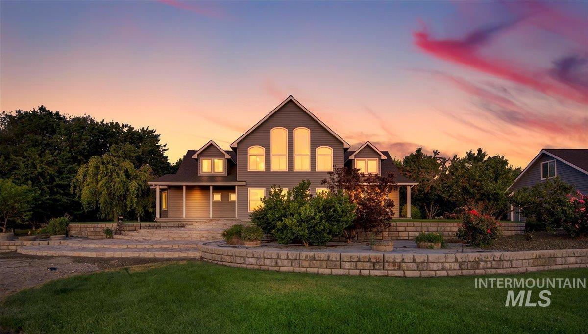 View of front facade with a yard and a porch