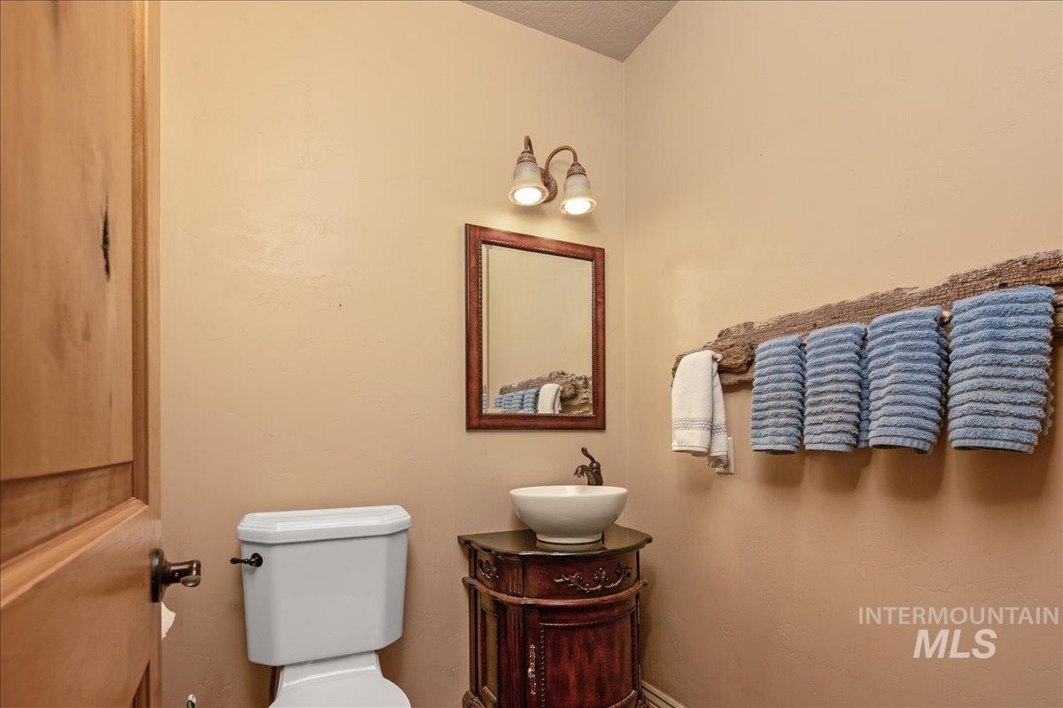 Half bathroom with toilet and vanity