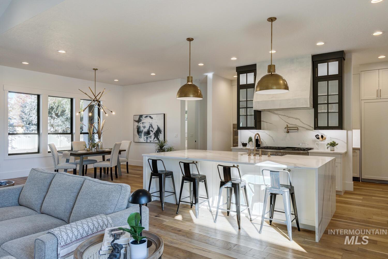 Living room with light wood-style flooring and recessed lighting