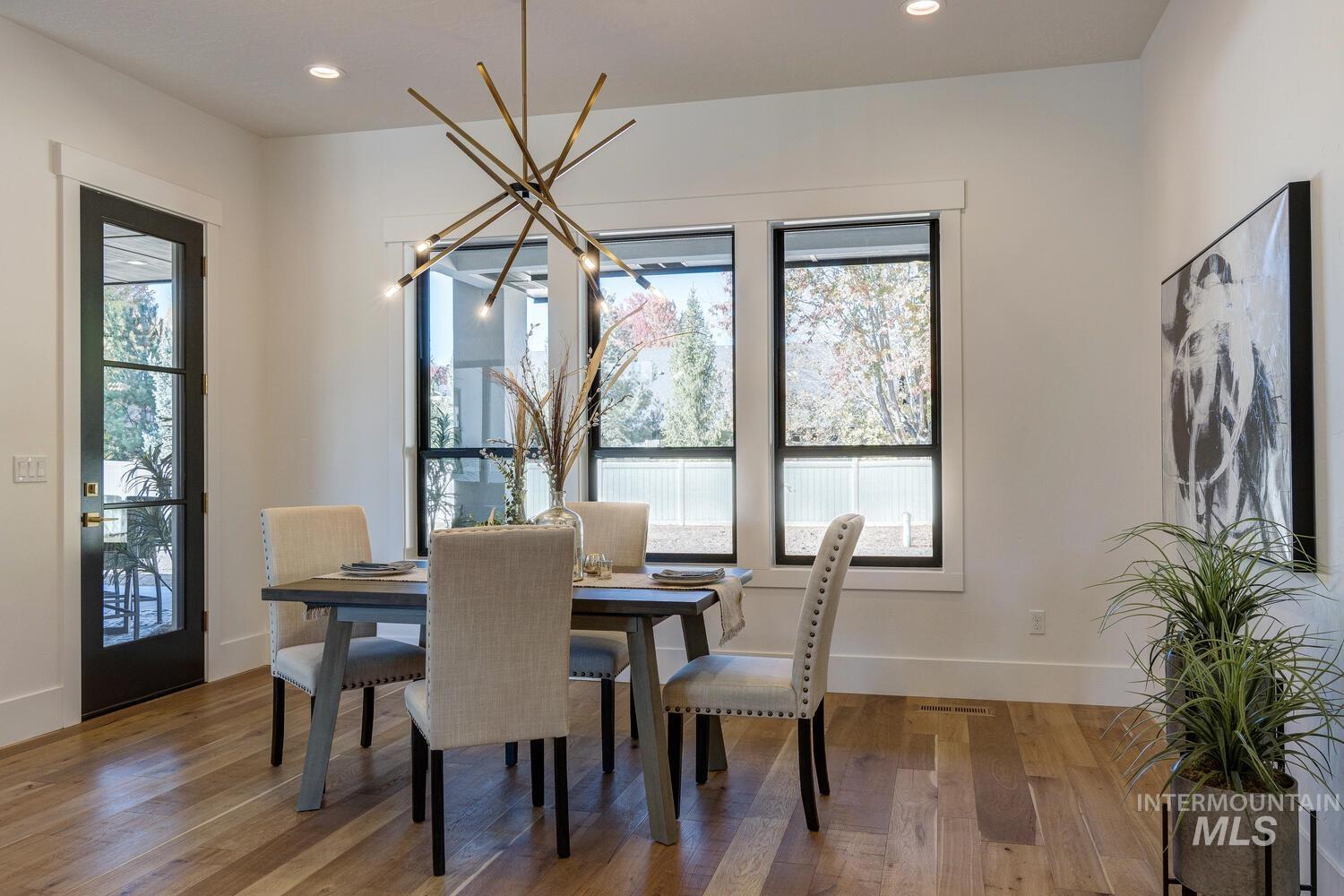 Dining room featuring light wood-style flooring, recessed lighting, and a chandelier
