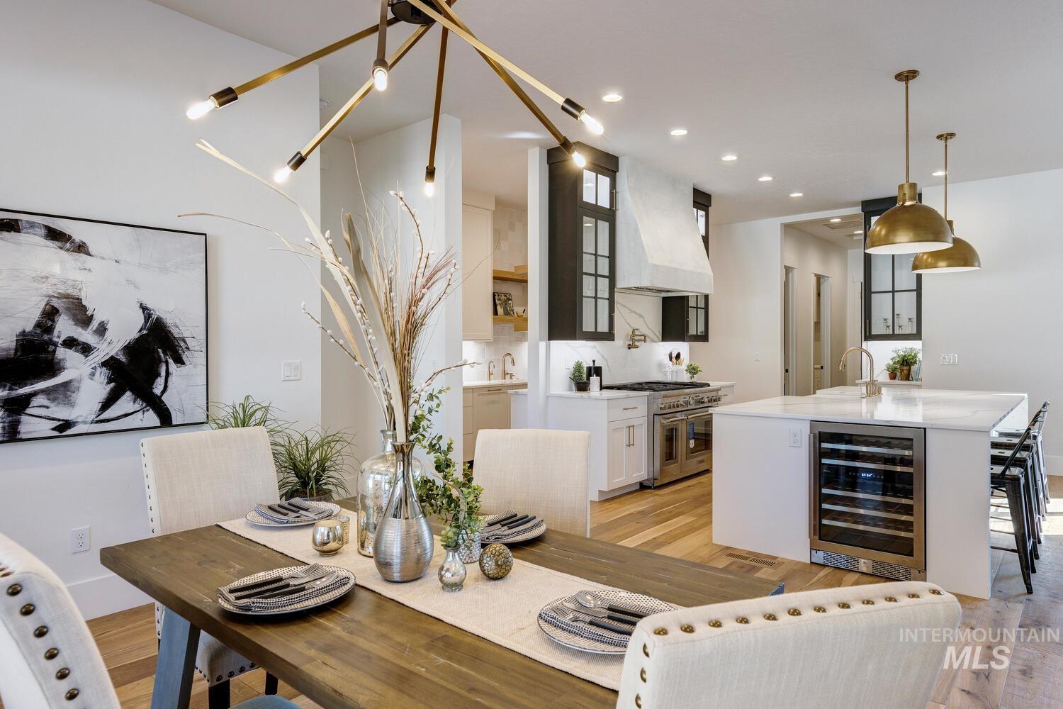 Dining room featuring light wood finished floors, wine cooler, and recessed lighting