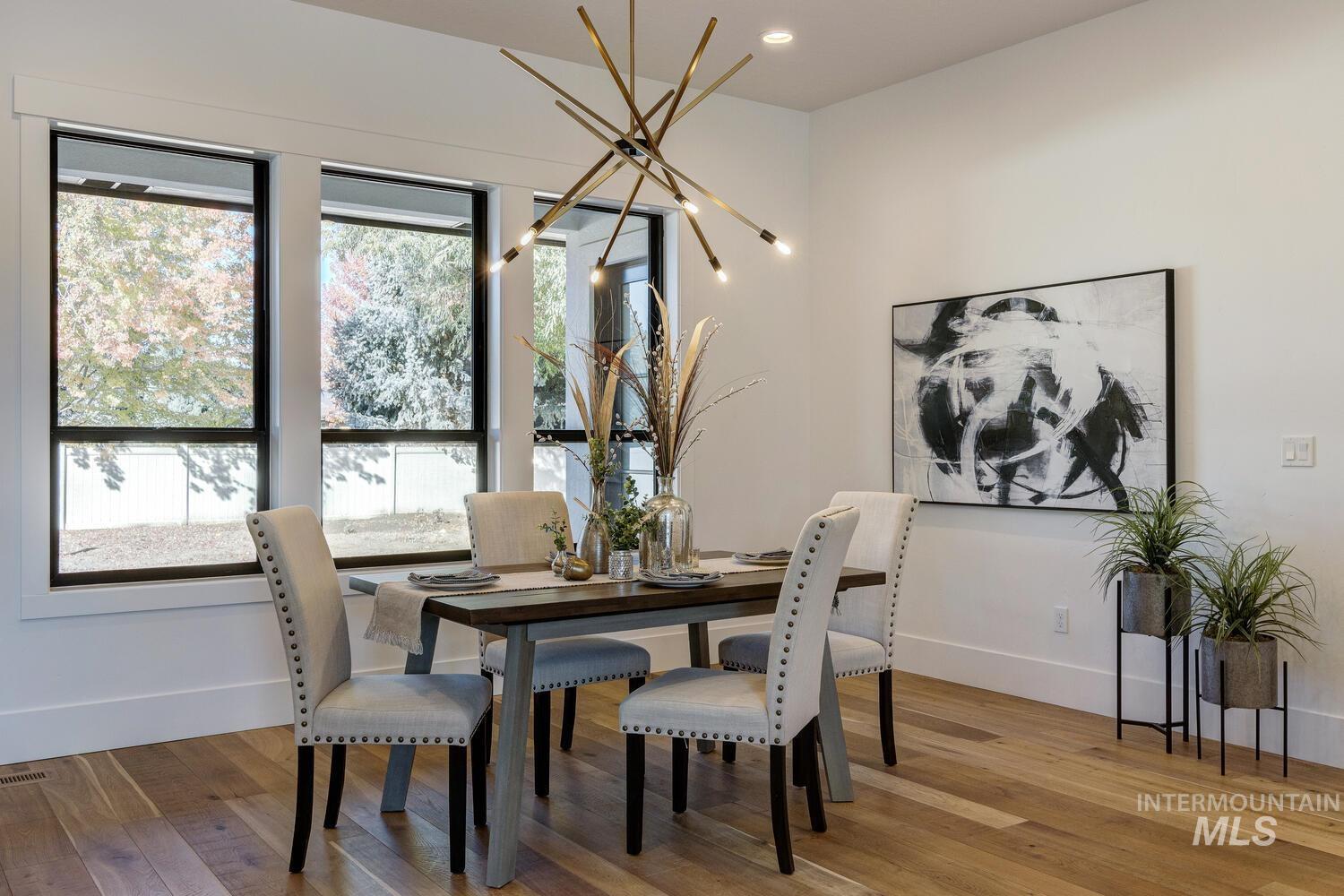 Dining area with wood finished floors and recessed lighting