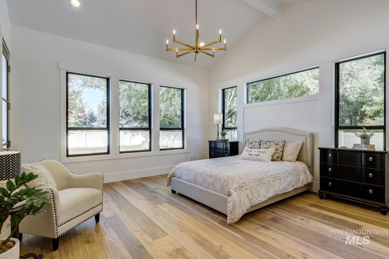 Bedroom with hardwood / wood-style floors, a chandelier, beamed ceiling, high vaulted ceiling, and recessed lighting