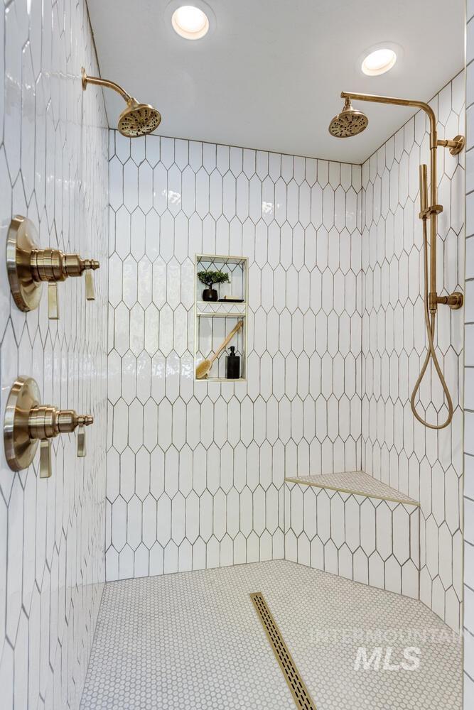 Bathroom featuring a tile shower and recessed lighting