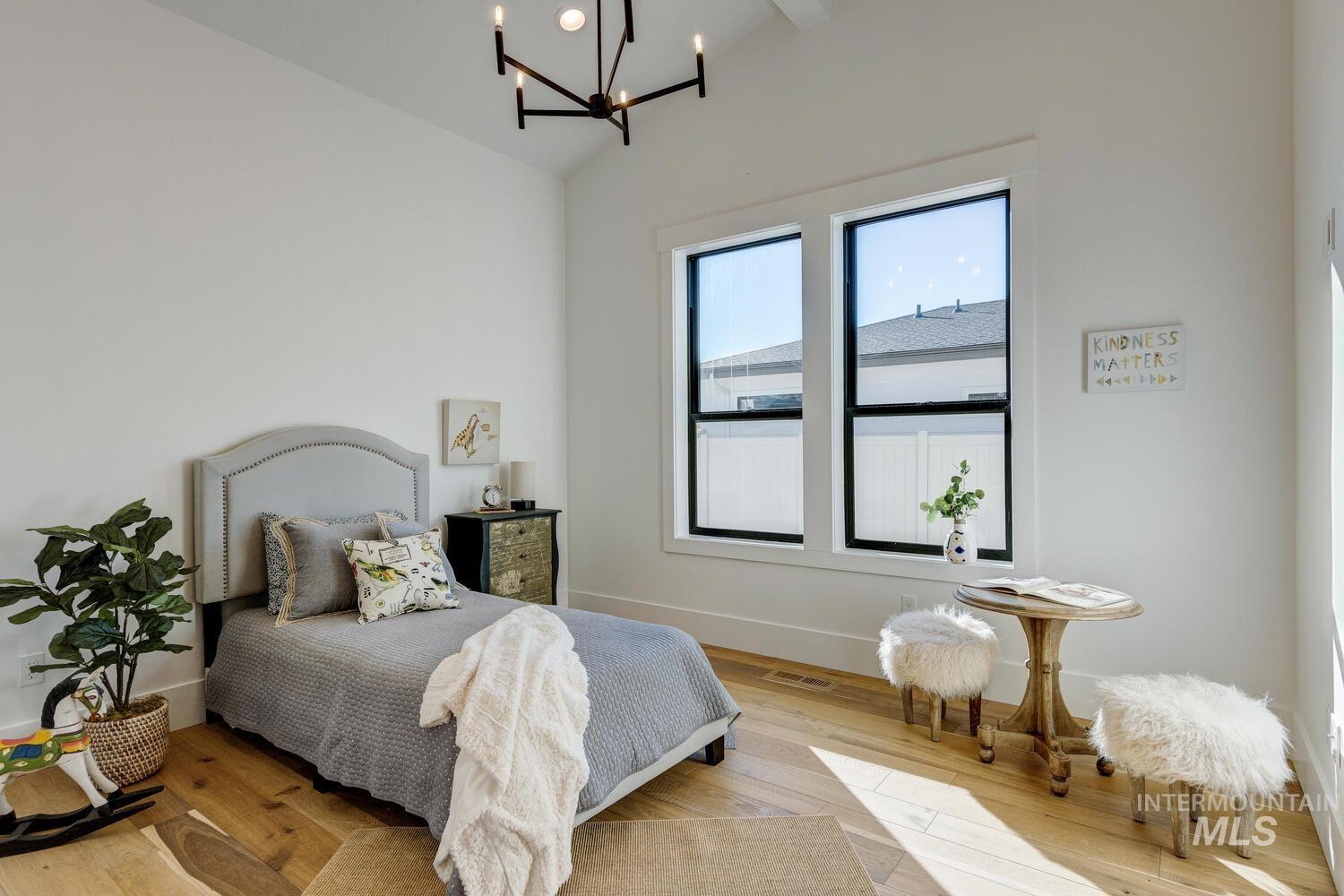 Bedroom with a chandelier and light wood-style floors