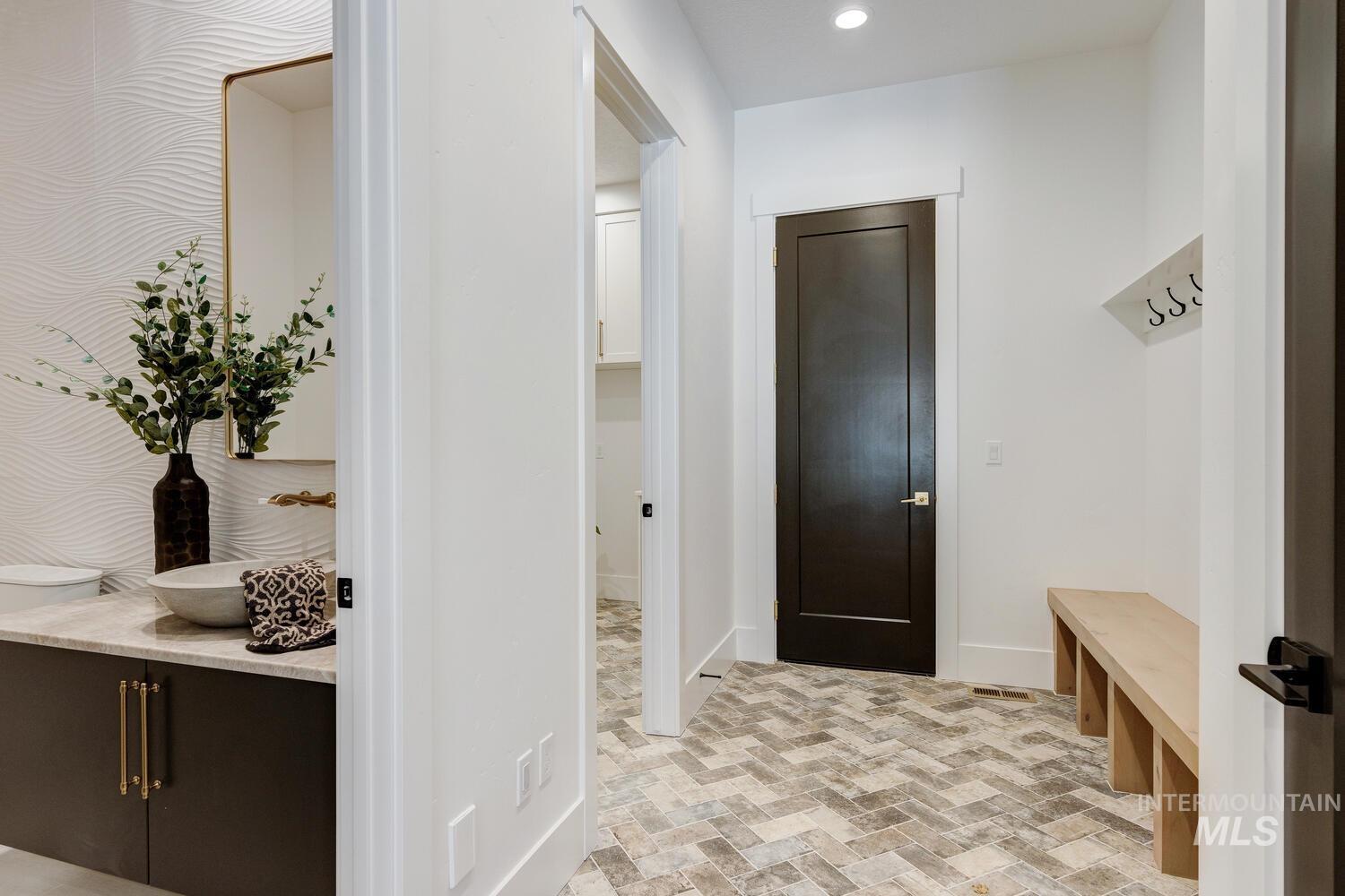 Mudroom with brick patterned flooring and recessed lighting