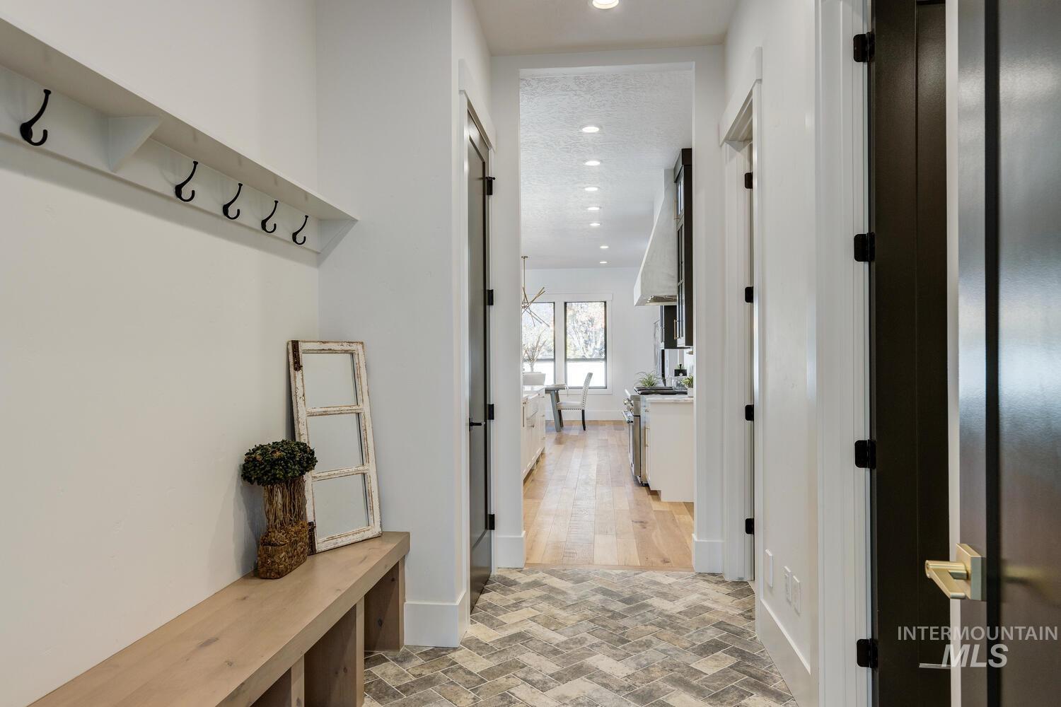 Mudroom with brick flooring and recessed lighting