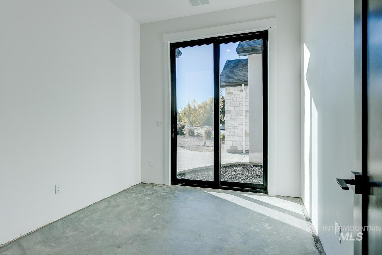 Doorway featuring unfinished concrete floors