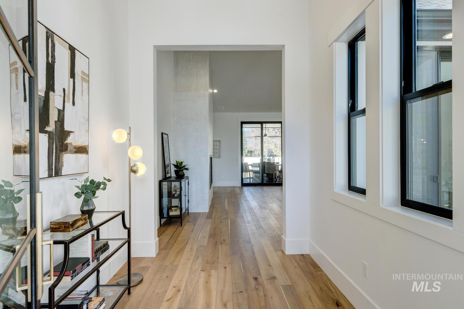 Hall with light wood-type flooring and baseboards