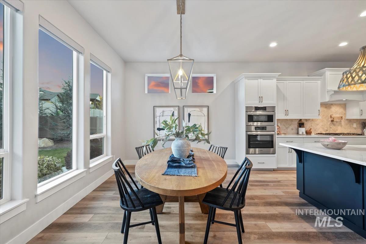 Dining area with recessed lighting and light wood finished floors