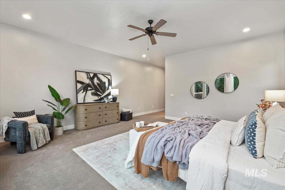 Carpeted bedroom with recessed lighting and ceiling fan