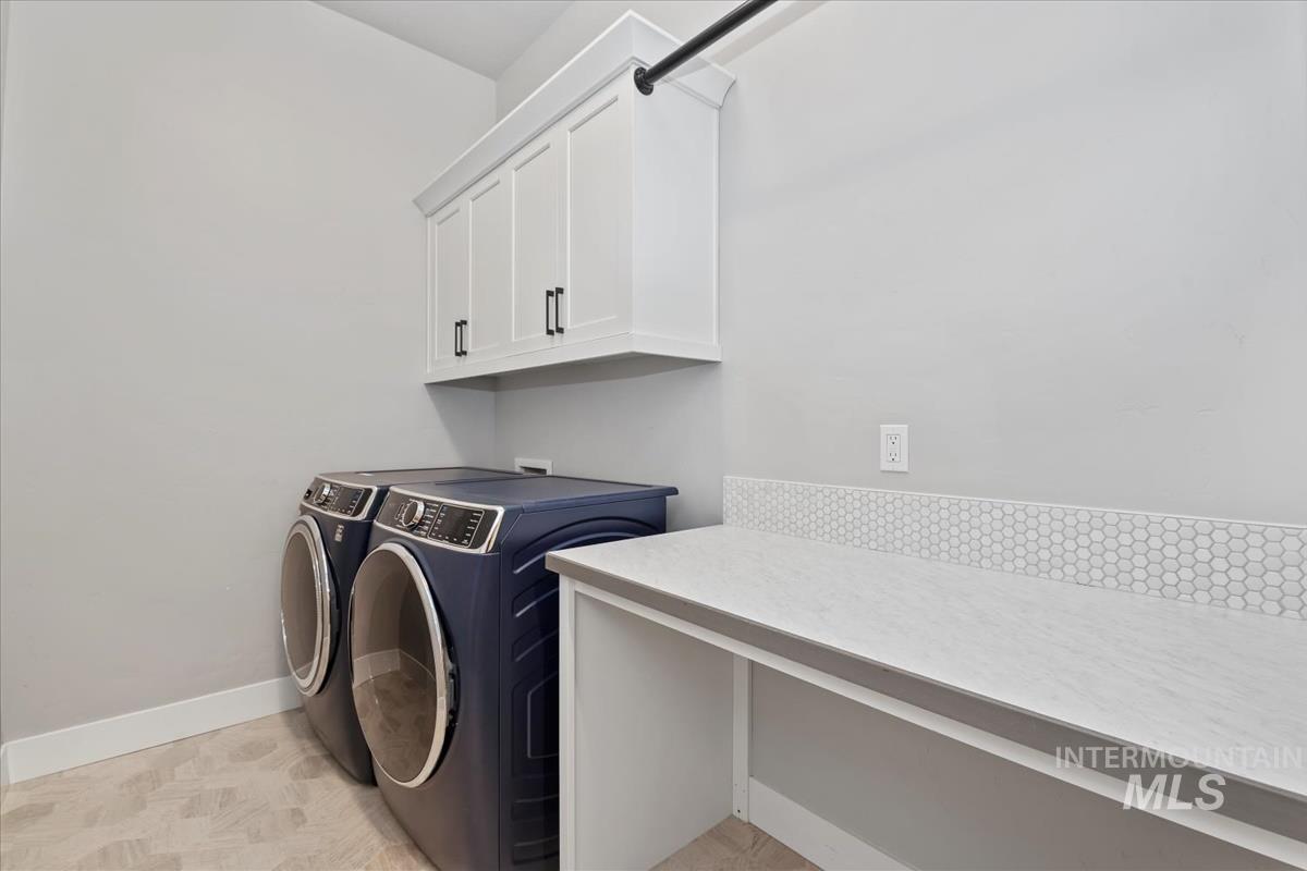 Laundry room featuring washing machine and dryer and cabinet space