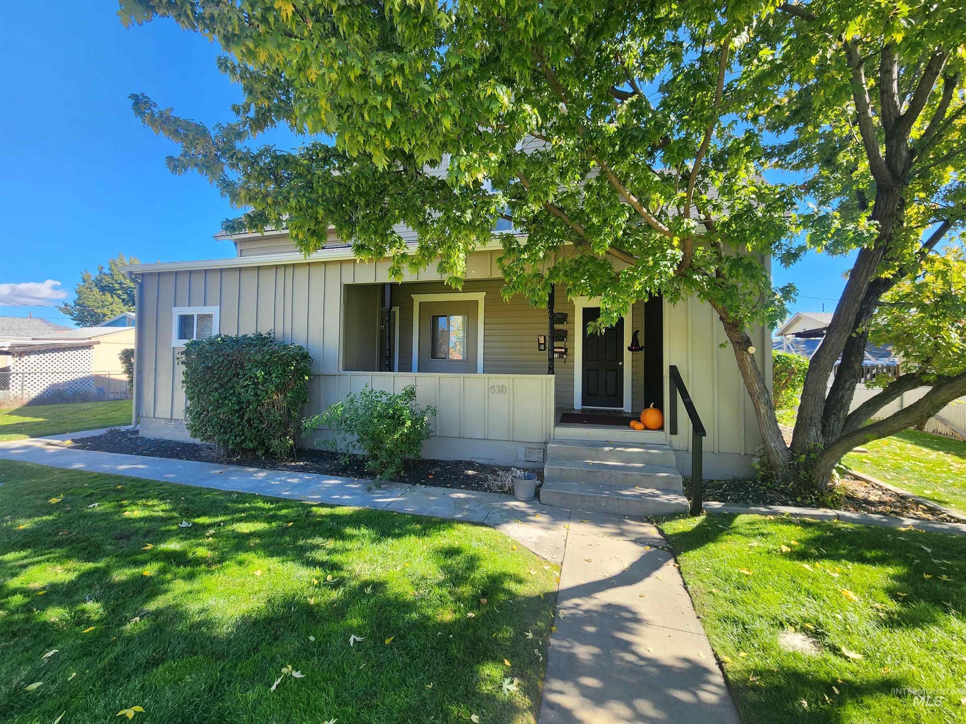 View of front of property featuring a front lawn, board and batten siding, and a porch