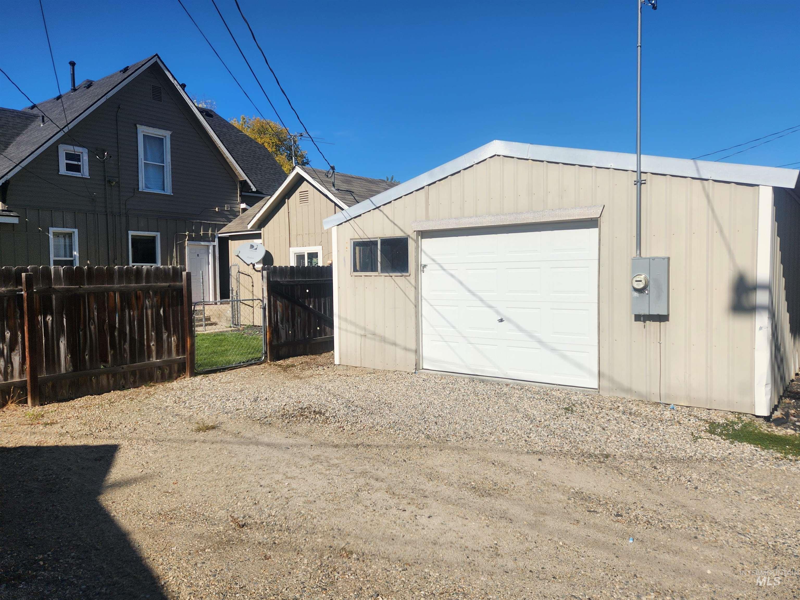 Garage with driveway and a gate
