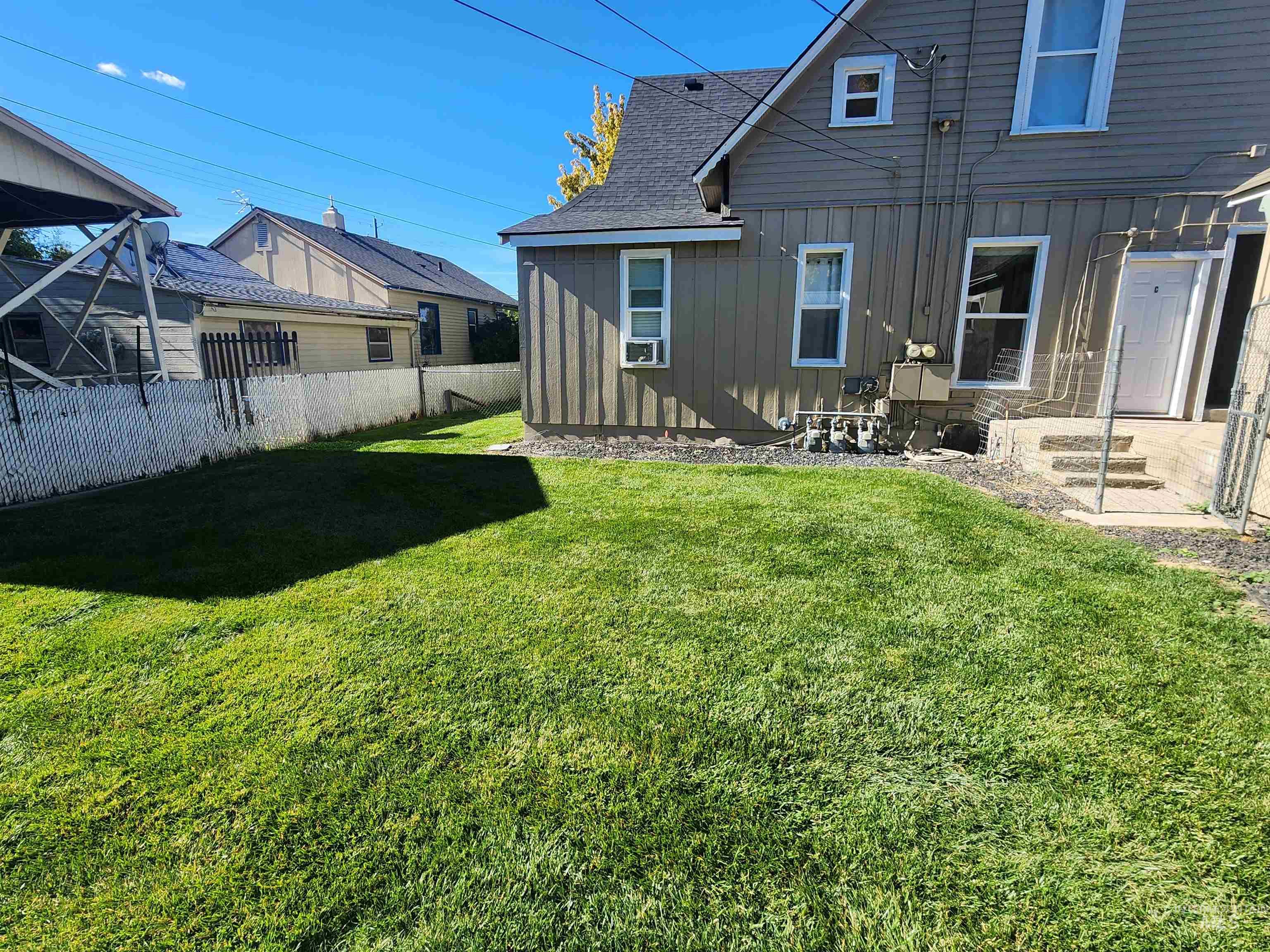 Back of property featuring board and batten siding and roof with shingles