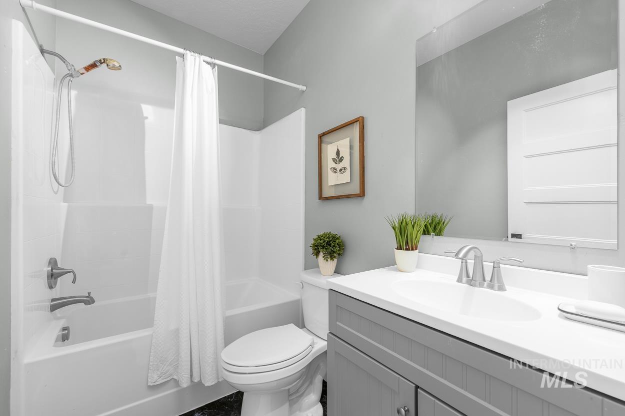 Bathroom with shower / bath combo and vanity