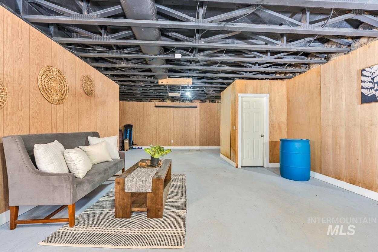 Below grade area featuring wood walls and baseboards