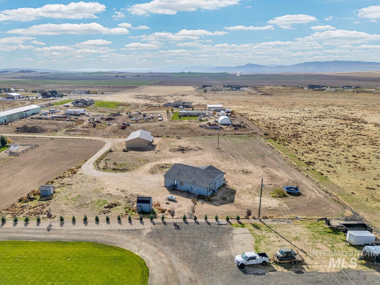 Aerial view of sparsely populated area with a mountain backdrop and a desert landscape