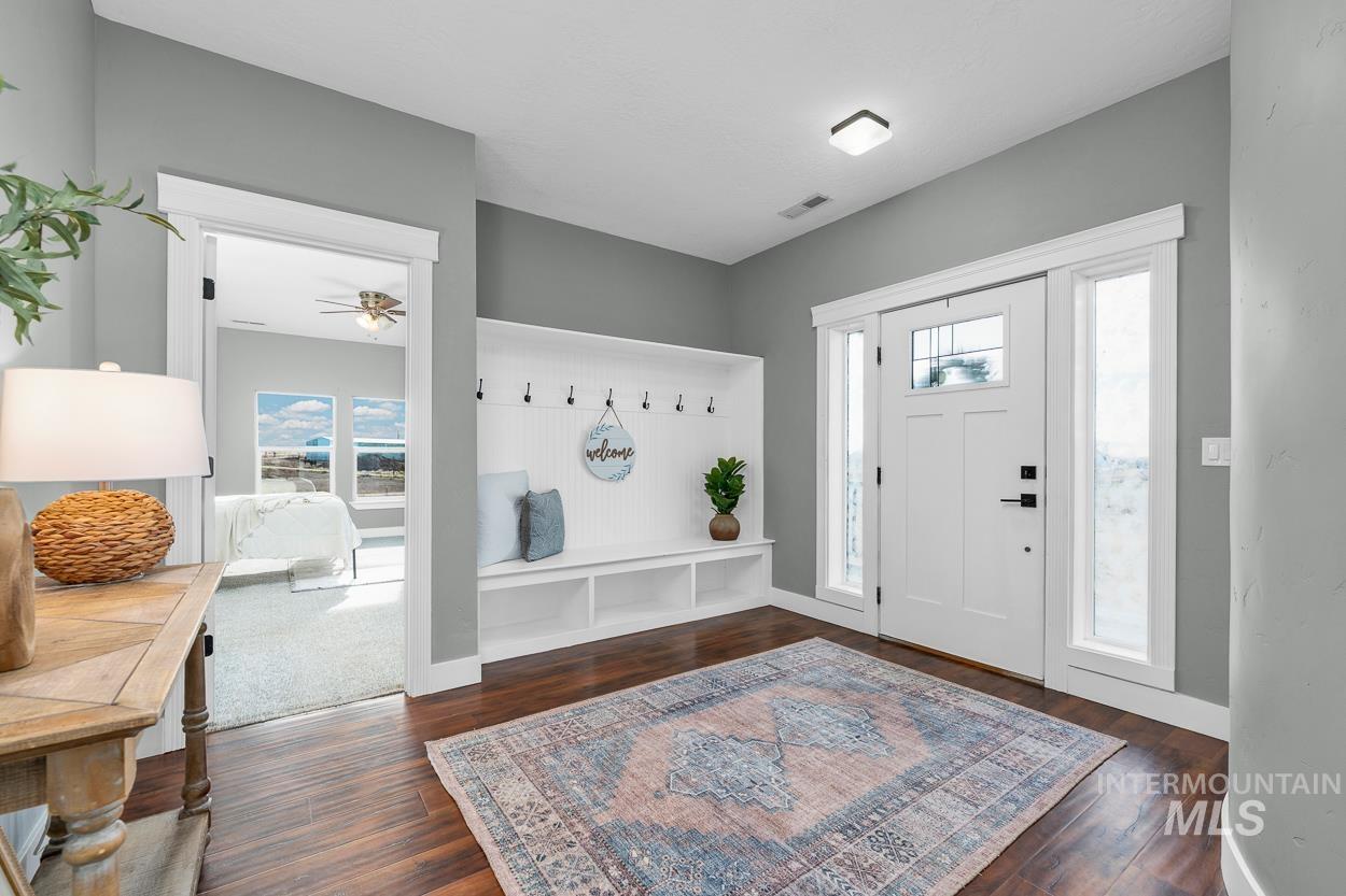 Entryway featuring dark wood finished floors and a ceiling fan