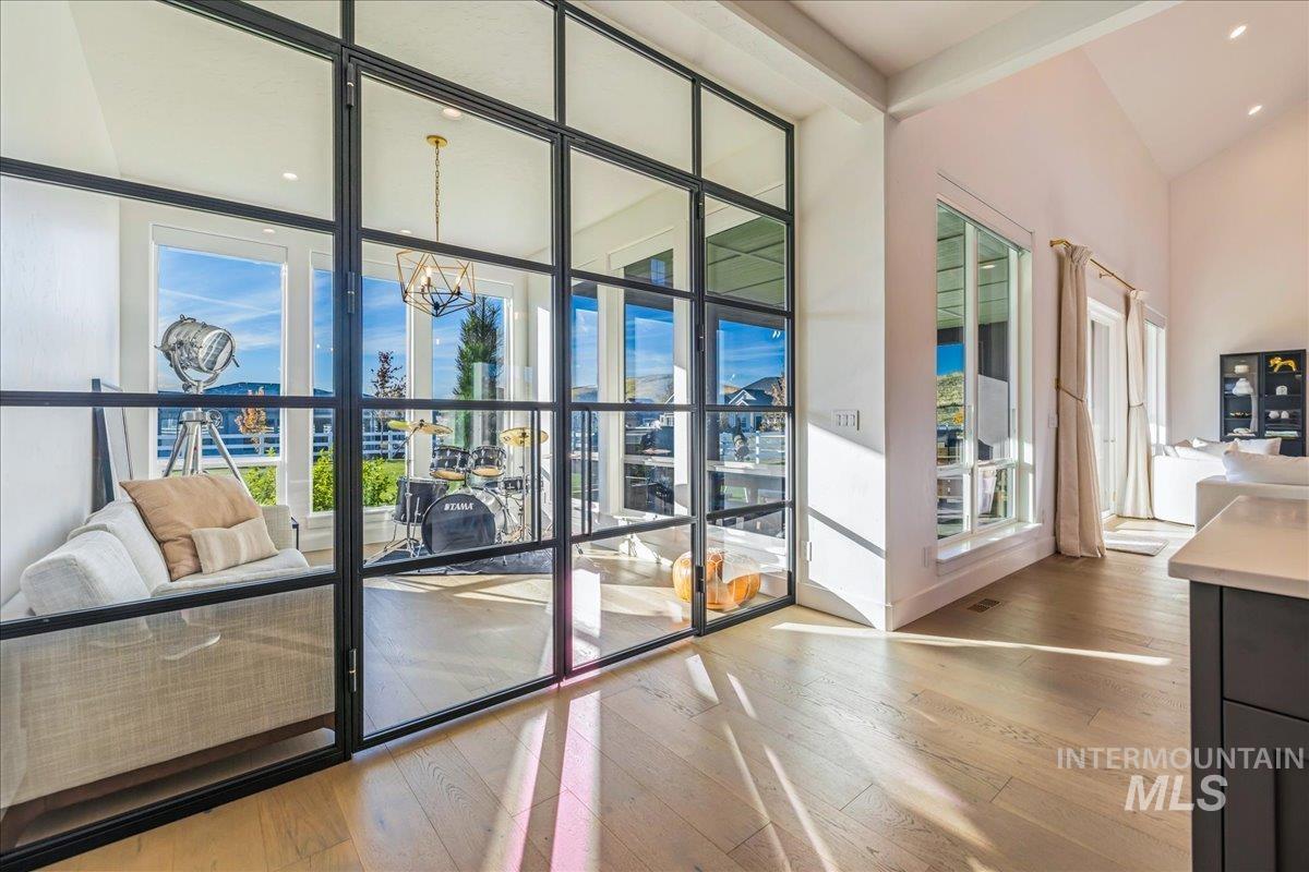 Doorway featuring a wall of windows, hardwood / wood-style floors, a chandelier, and recessed lighting
