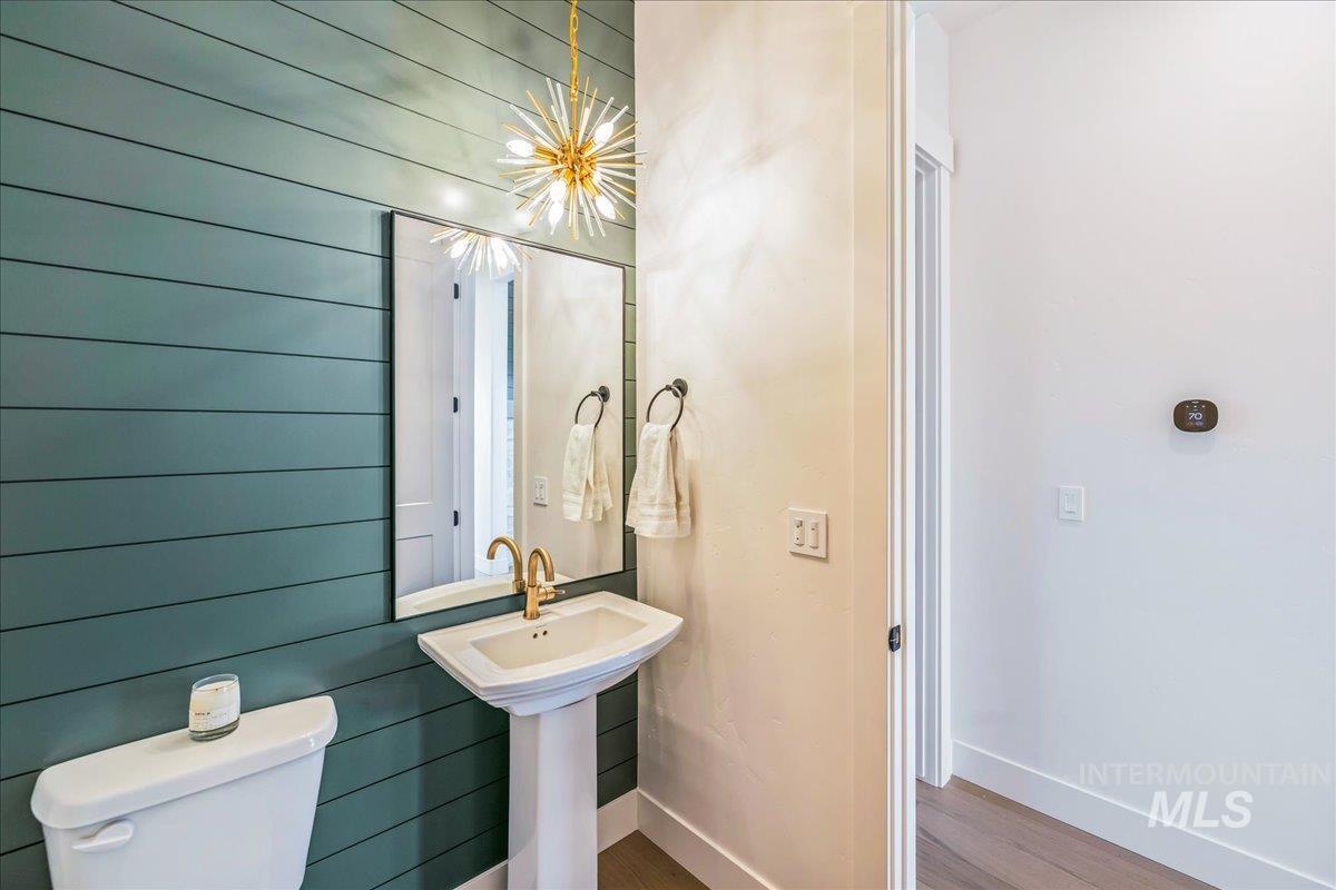 Bathroom with wood finished floors and wood walls