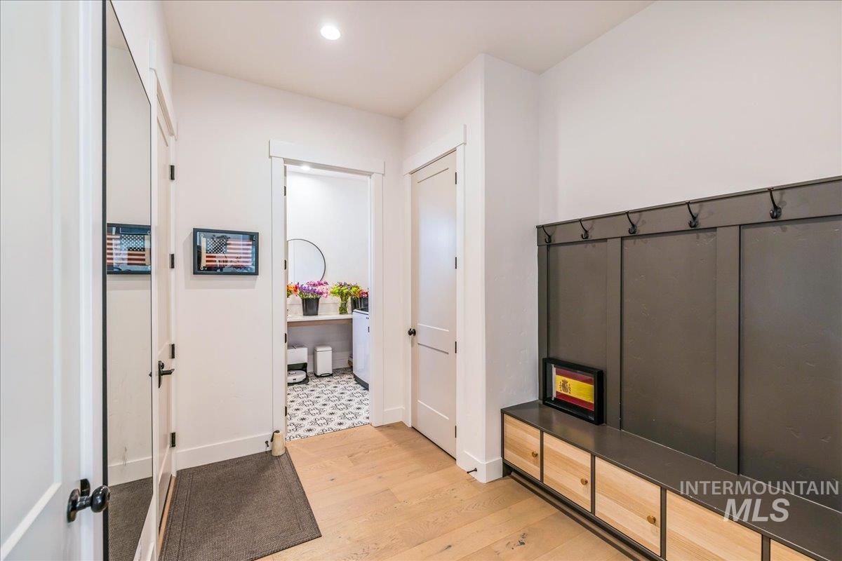 Mudroom featuring light wood-style flooring and recessed lighting