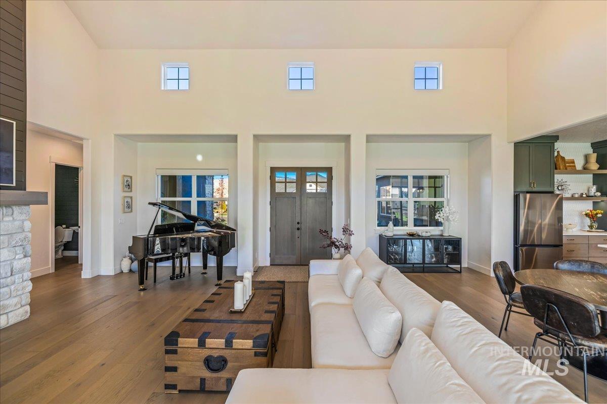 Living area featuring dark wood-type flooring and a high ceiling