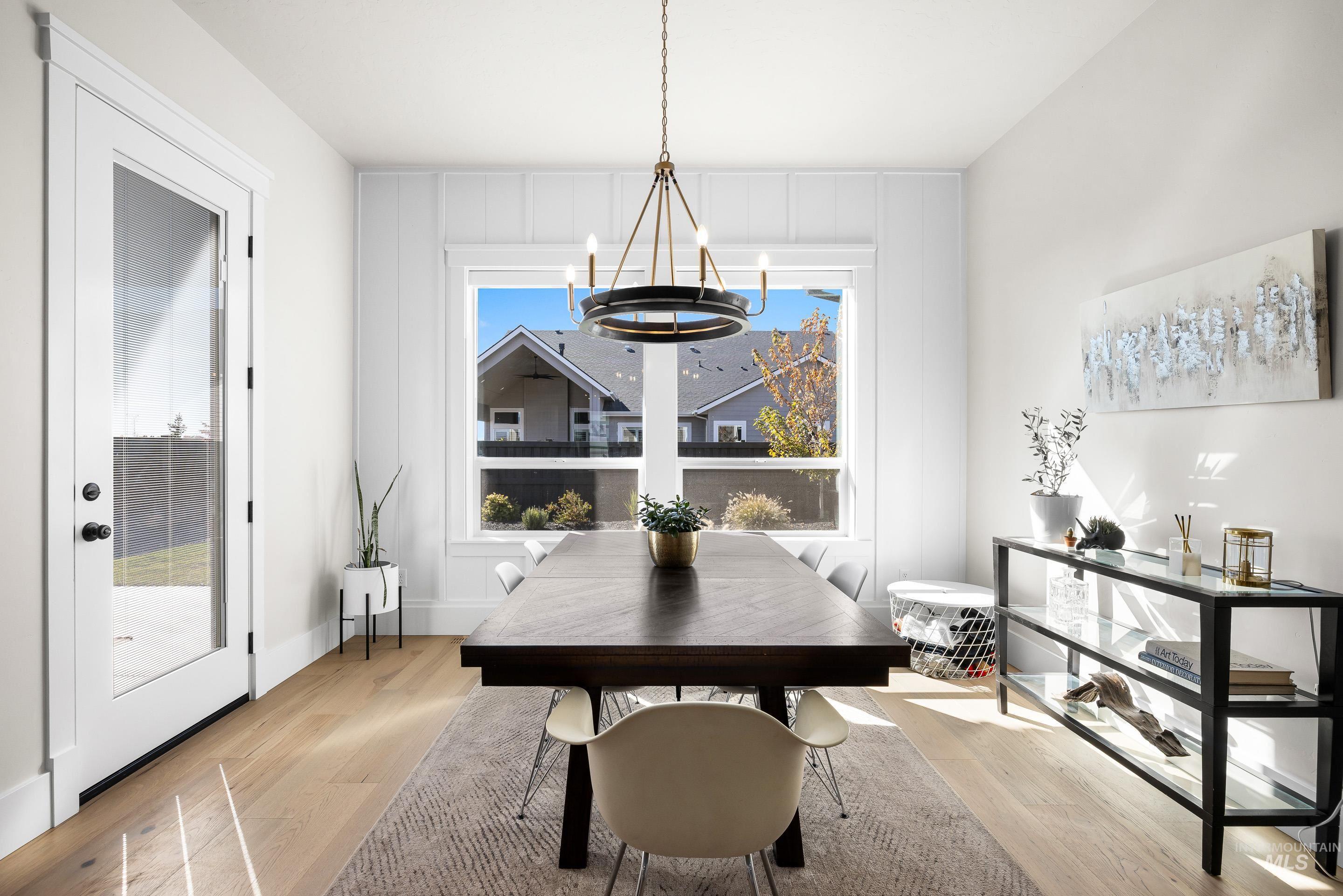 Dining area with light wood-style floors and a chandelier