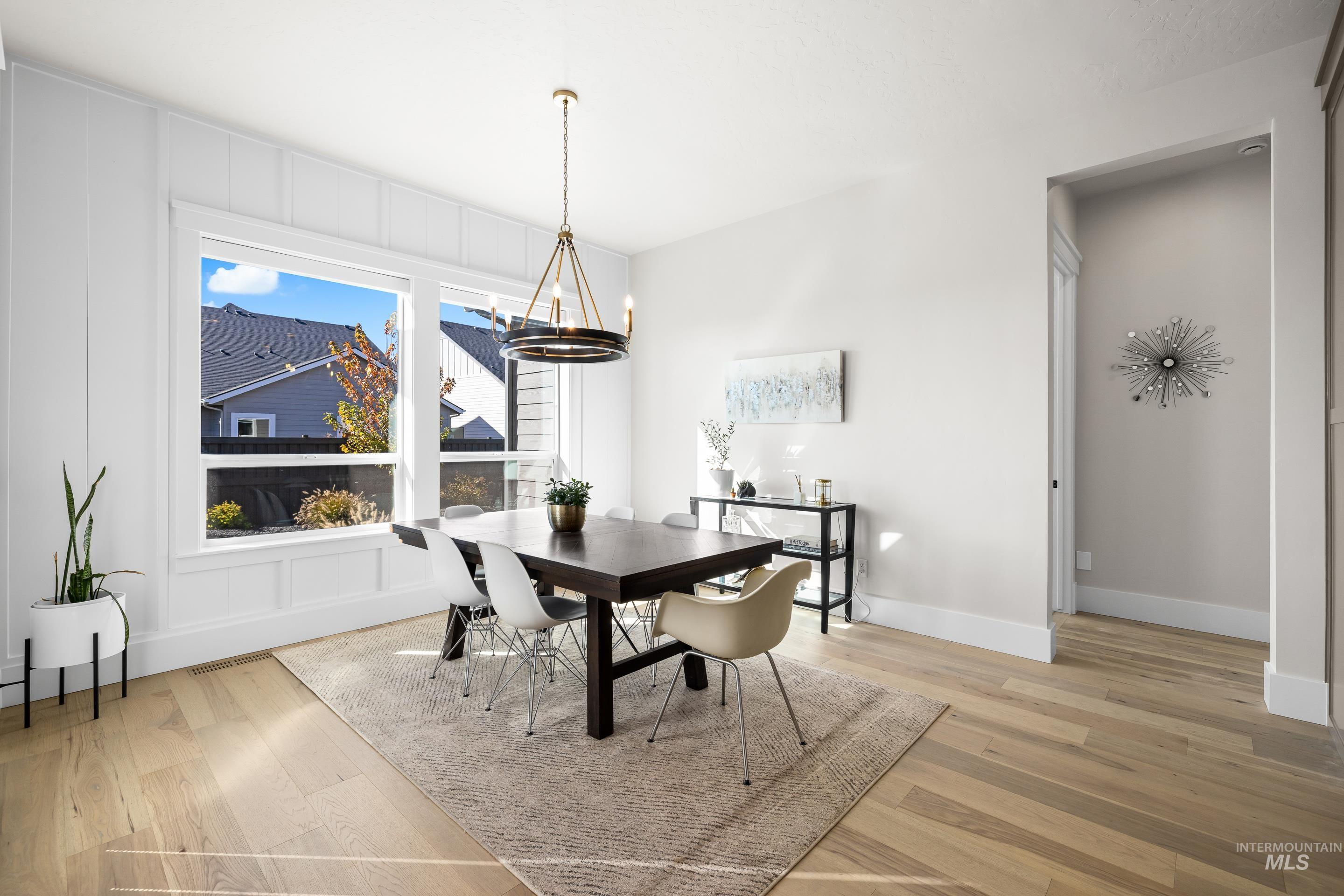 Dining area featuring a chandelier and light wood-type flooring