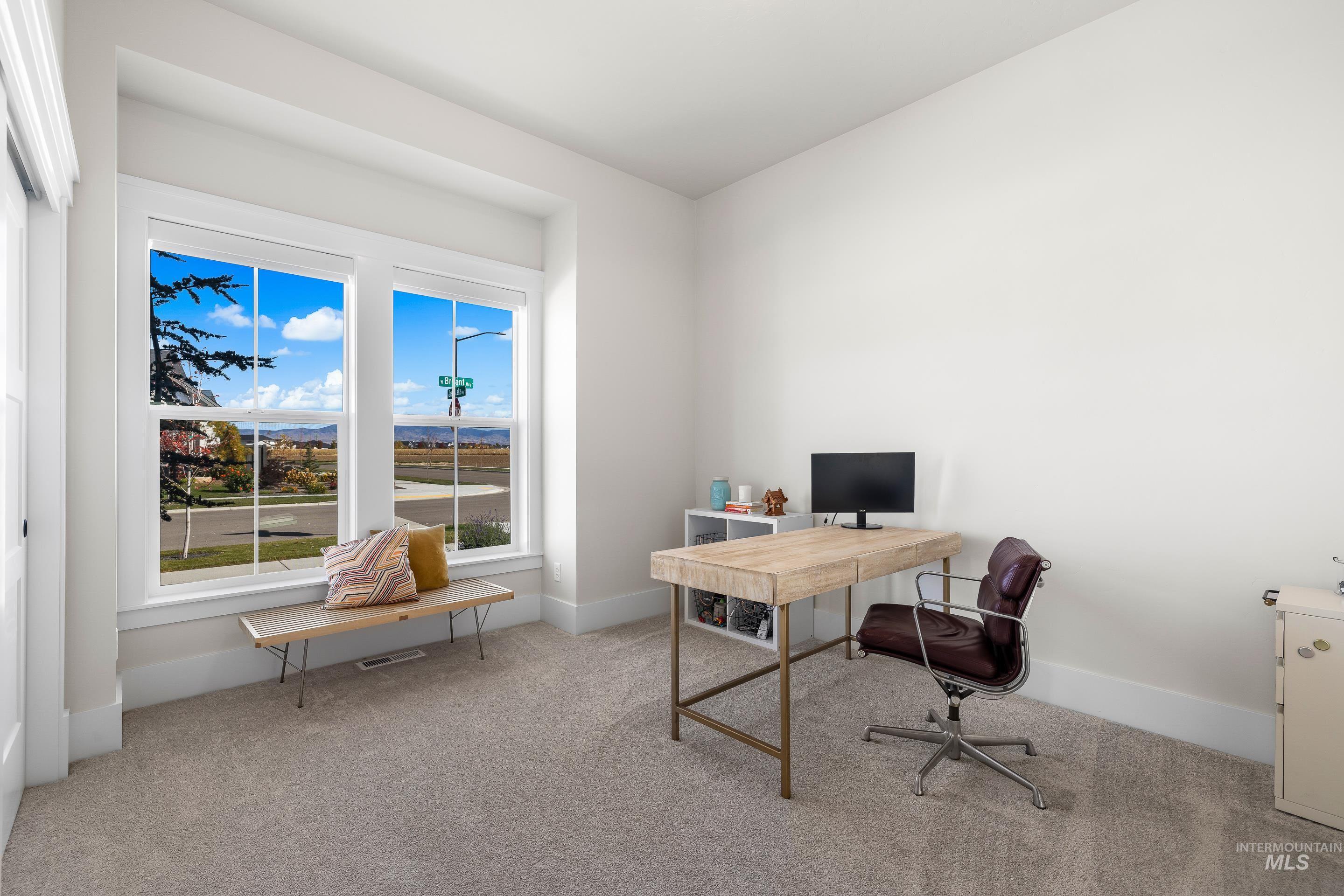 Office with light carpet and baseboards