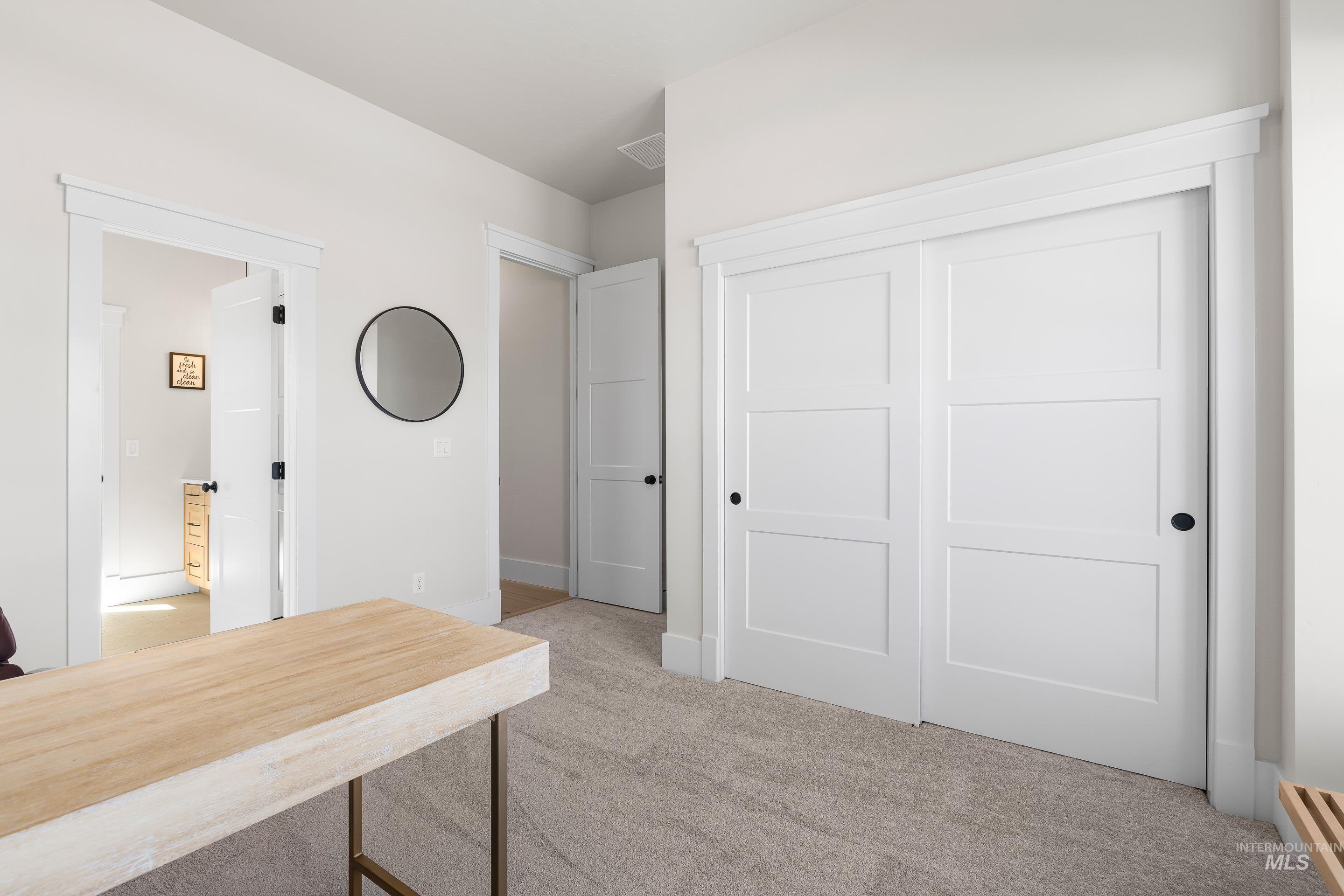 Unfurnished office with light carpet and baseboards