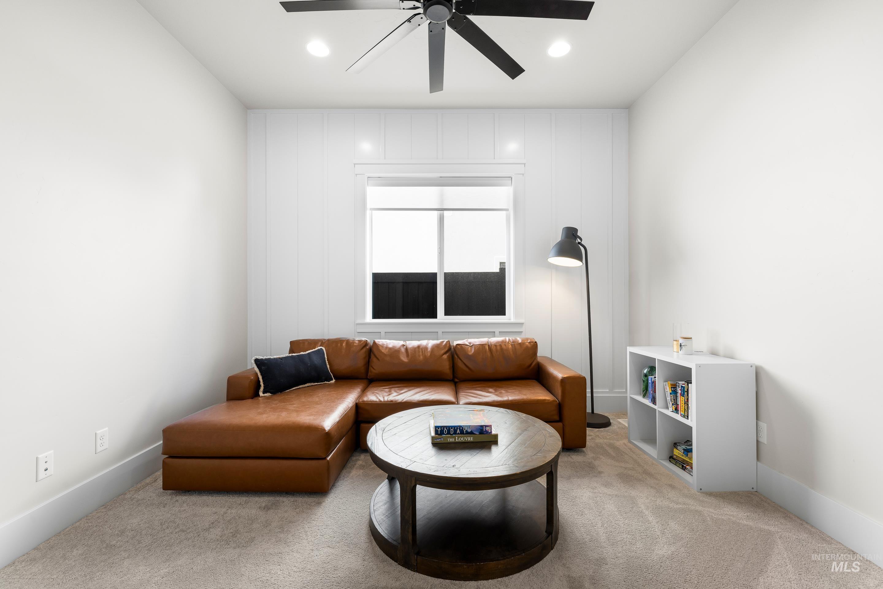 Living room with light carpet, ceiling fan, and recessed lighting