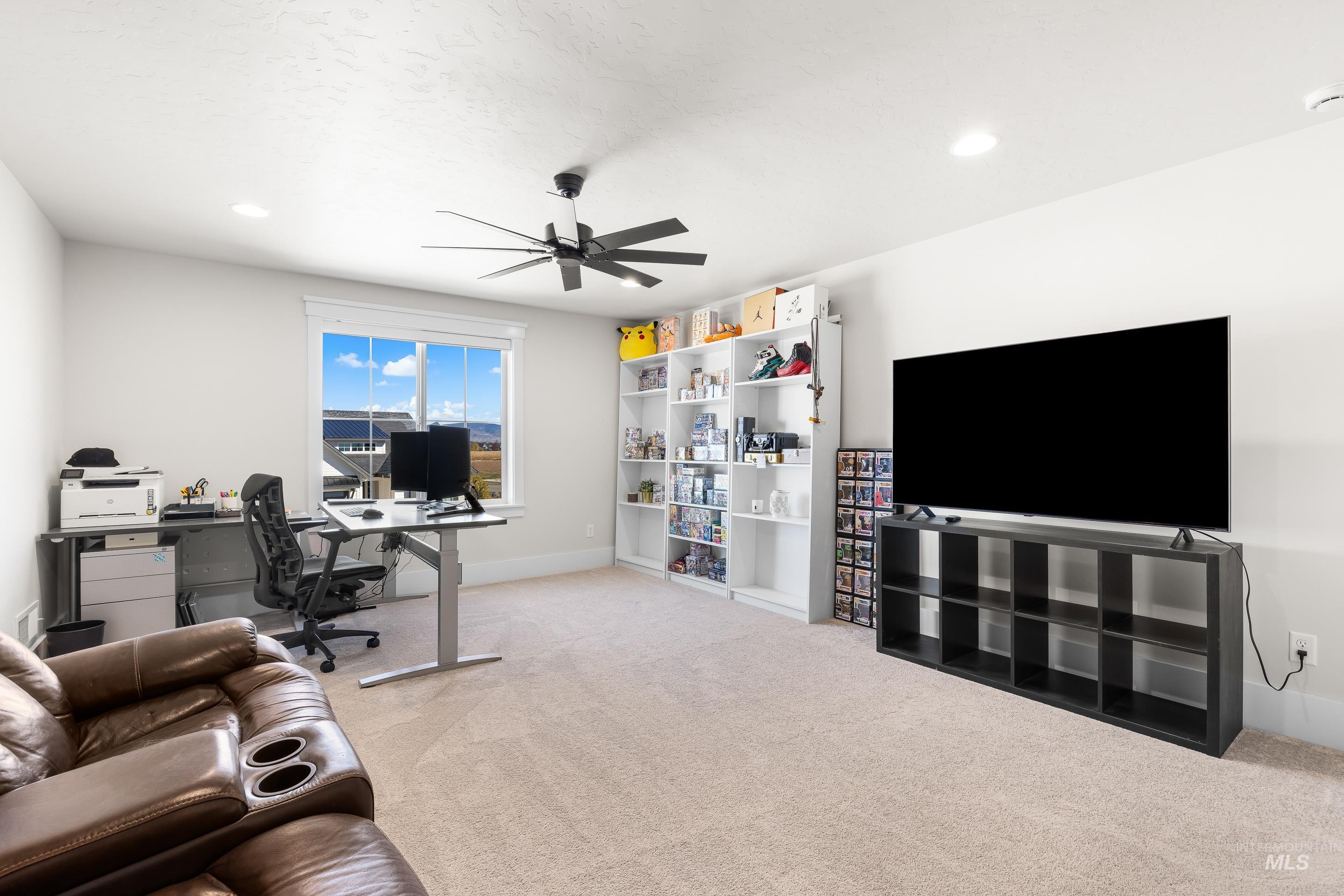 Office space featuring light colored carpet, a ceiling fan, and recessed lighting