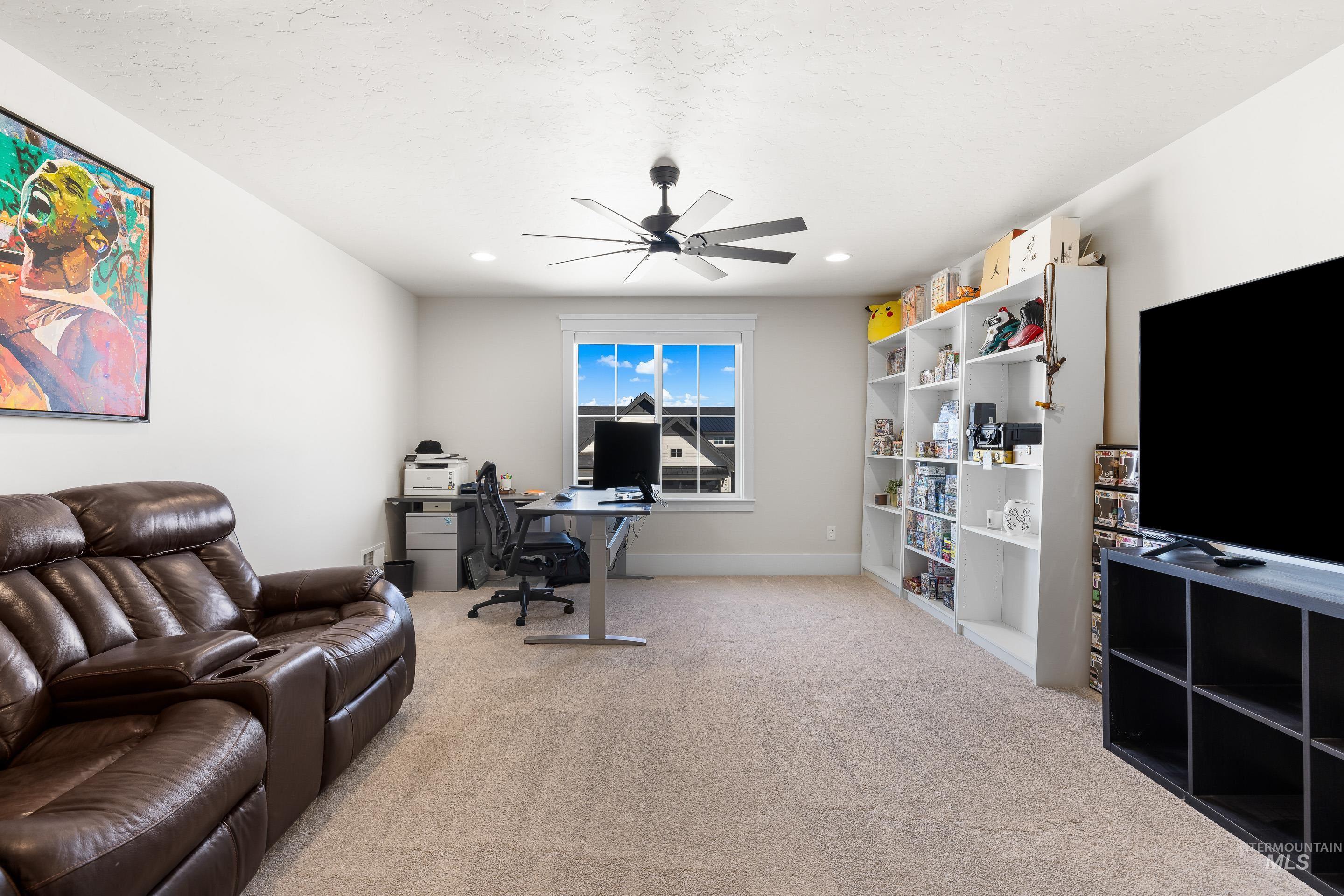 Office featuring light colored carpet and ceiling fan