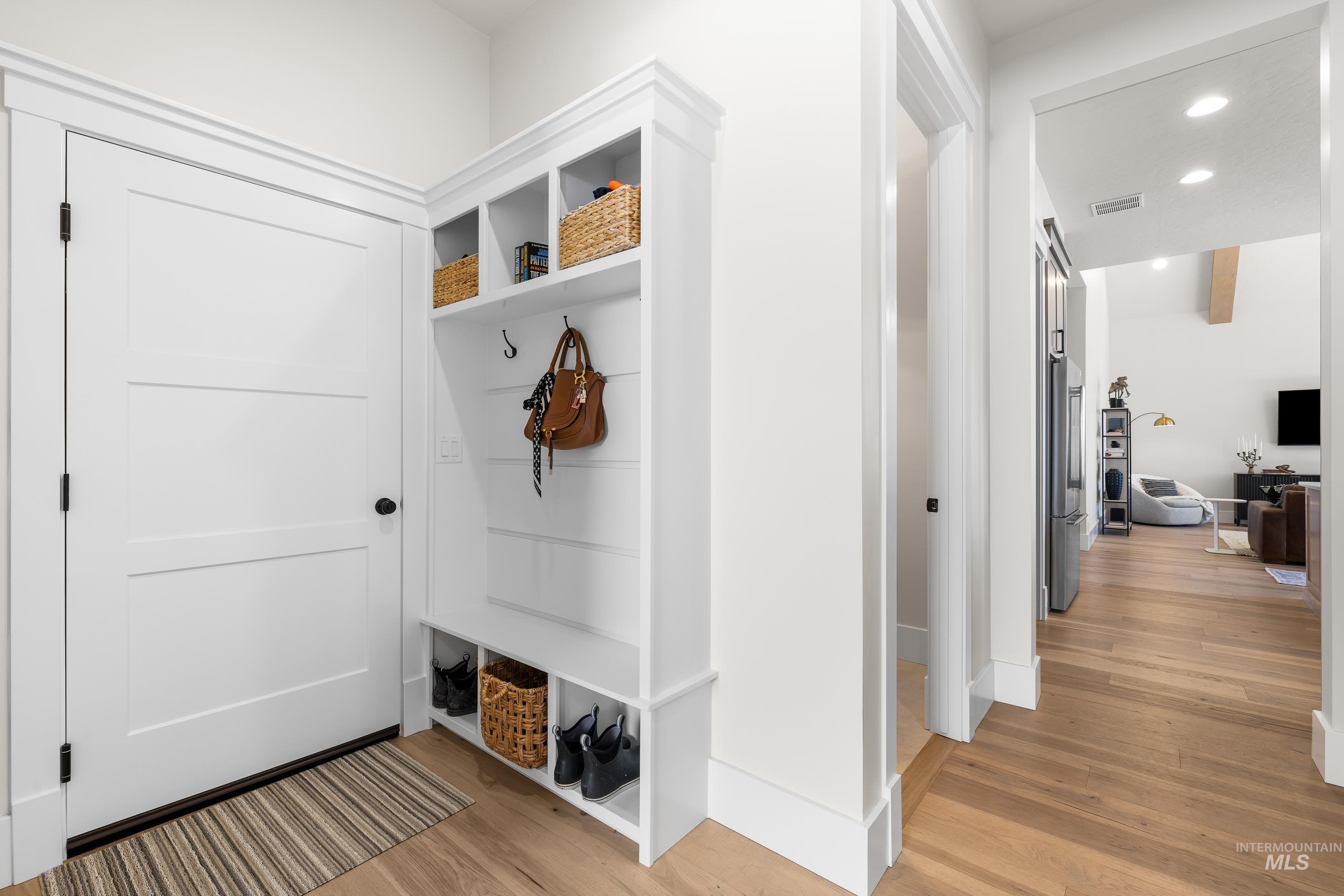Mudroom featuring light wood-type flooring and recessed lighting