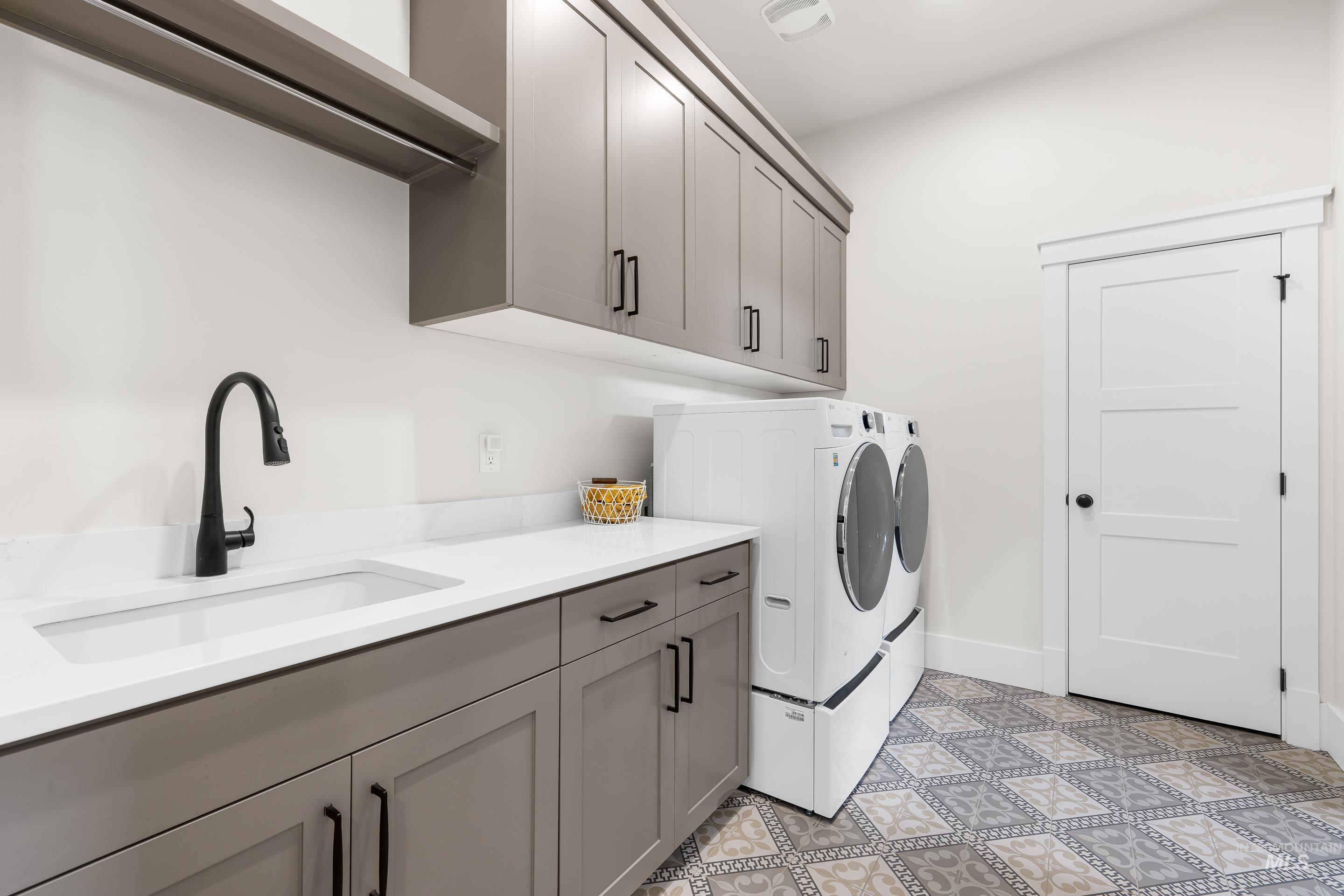 Washroom featuring cabinet space and separate washer and dryer