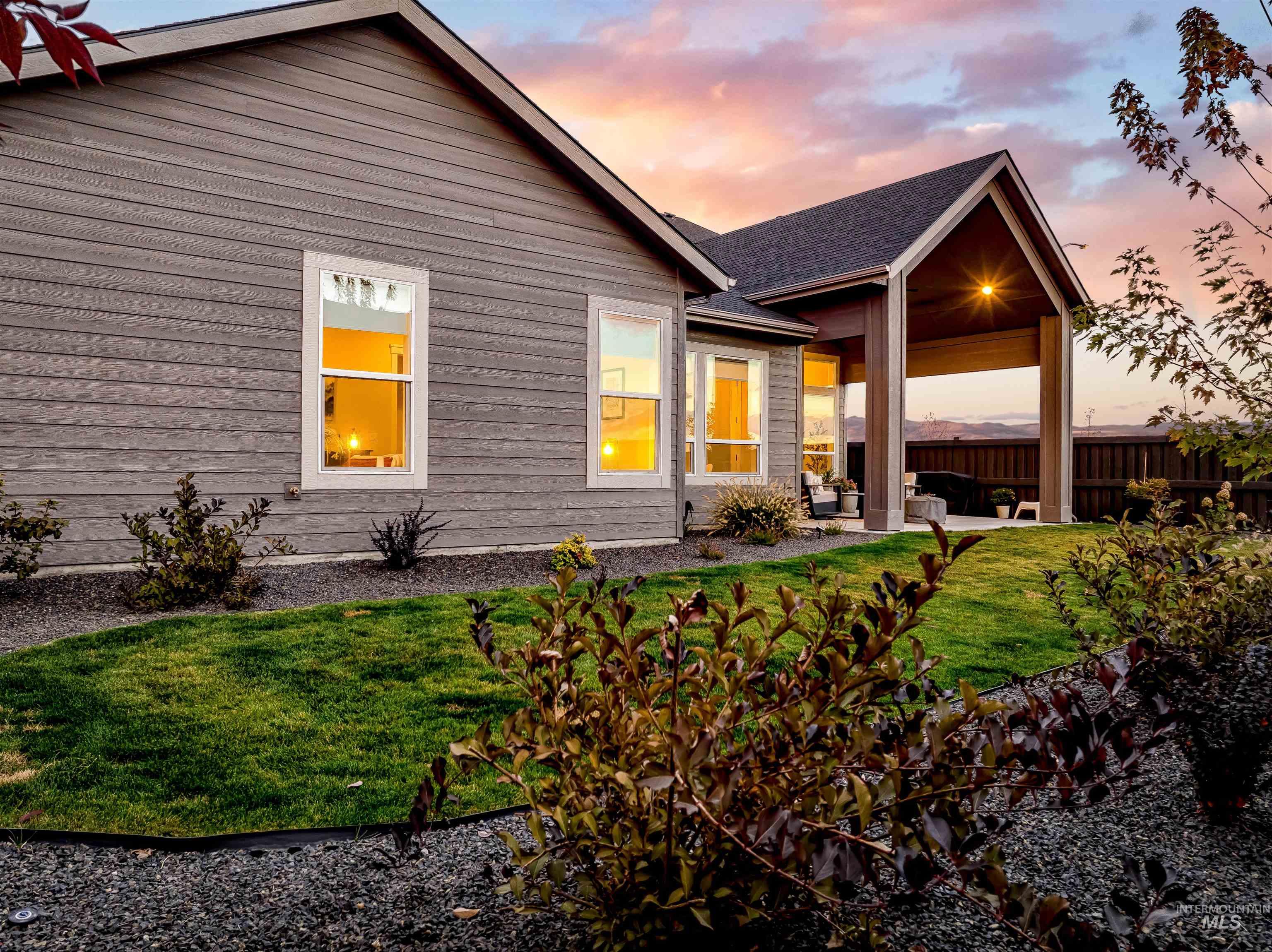 Back of house at dusk featuring a patio