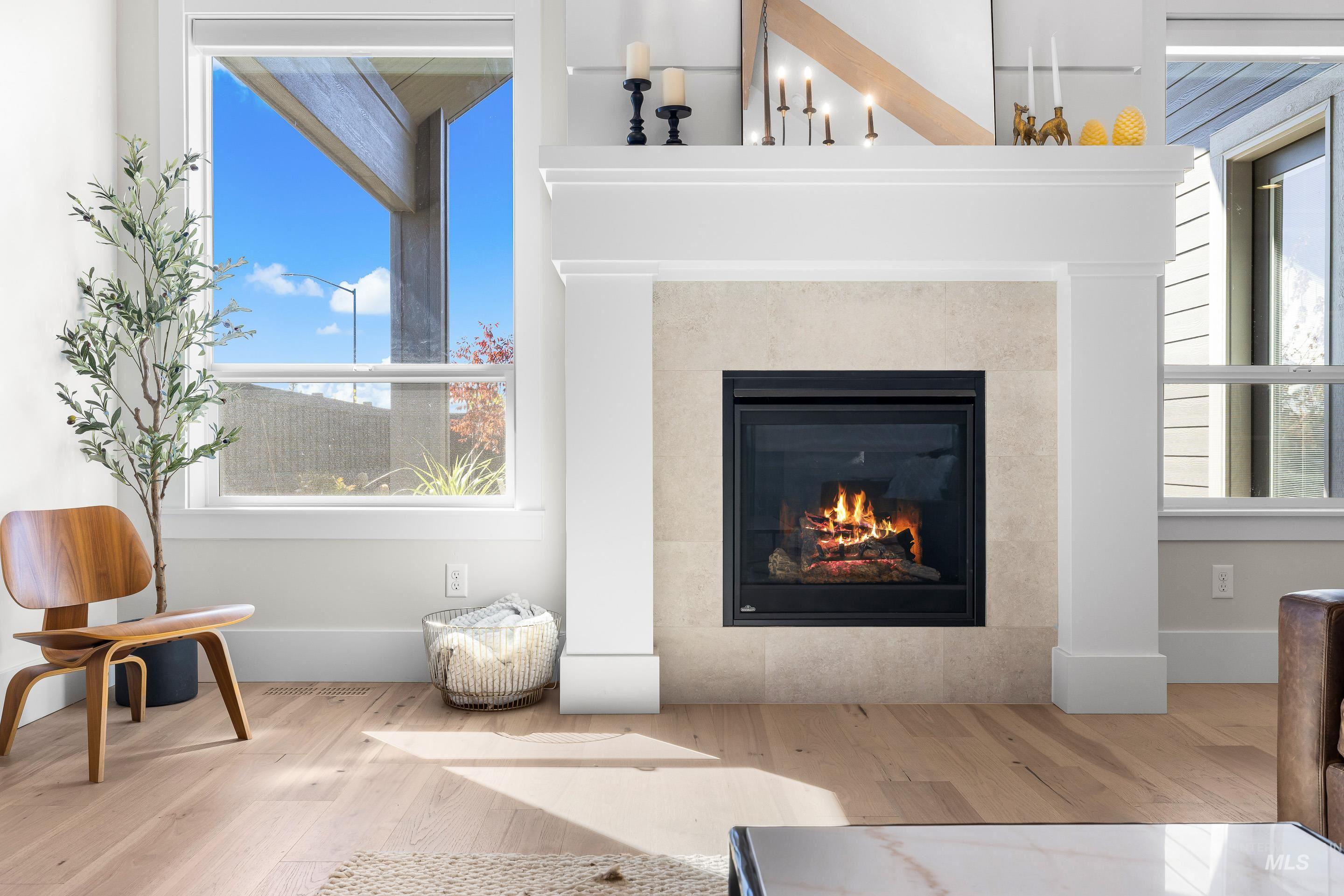 Detailed view of wood finished floors and a tile fireplace