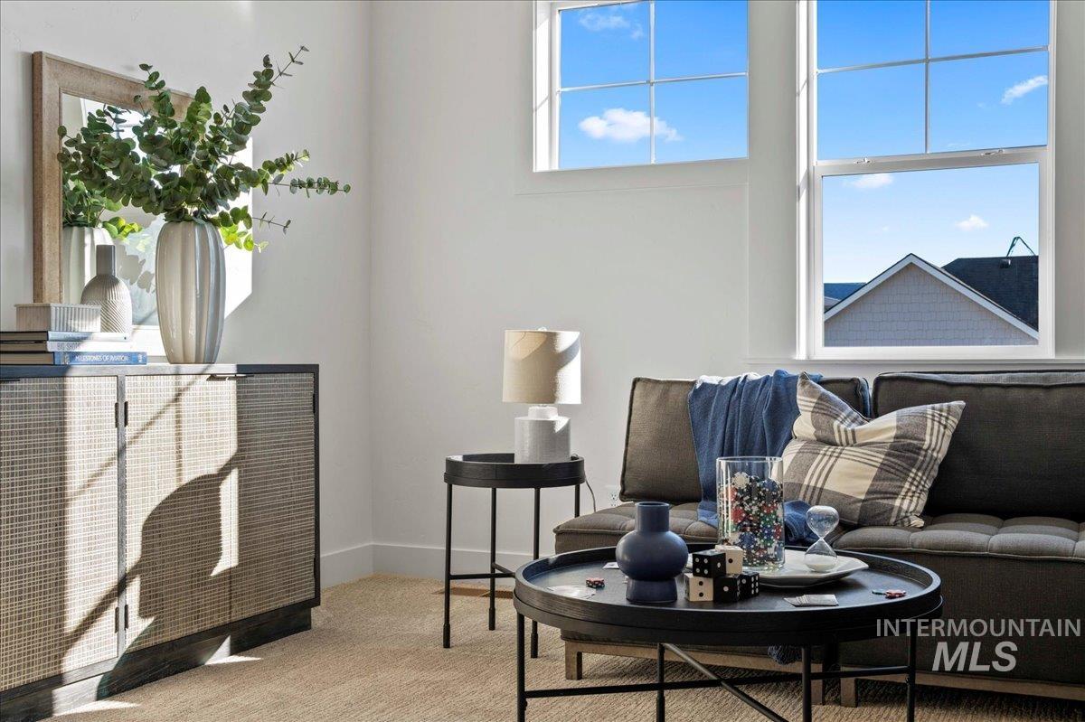 Living room with carpet floors and baseboards